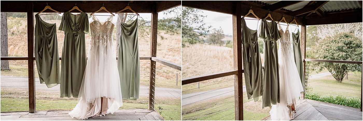 Bridal gown and sage green bridesmaid dresses, hanging from roof on the deck of Rose Cottage