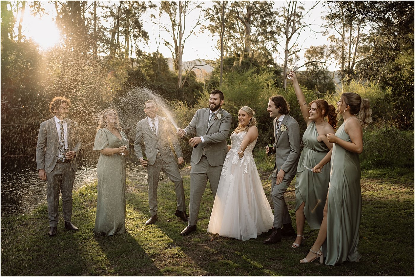 Bridal party popping and spraying champagne
