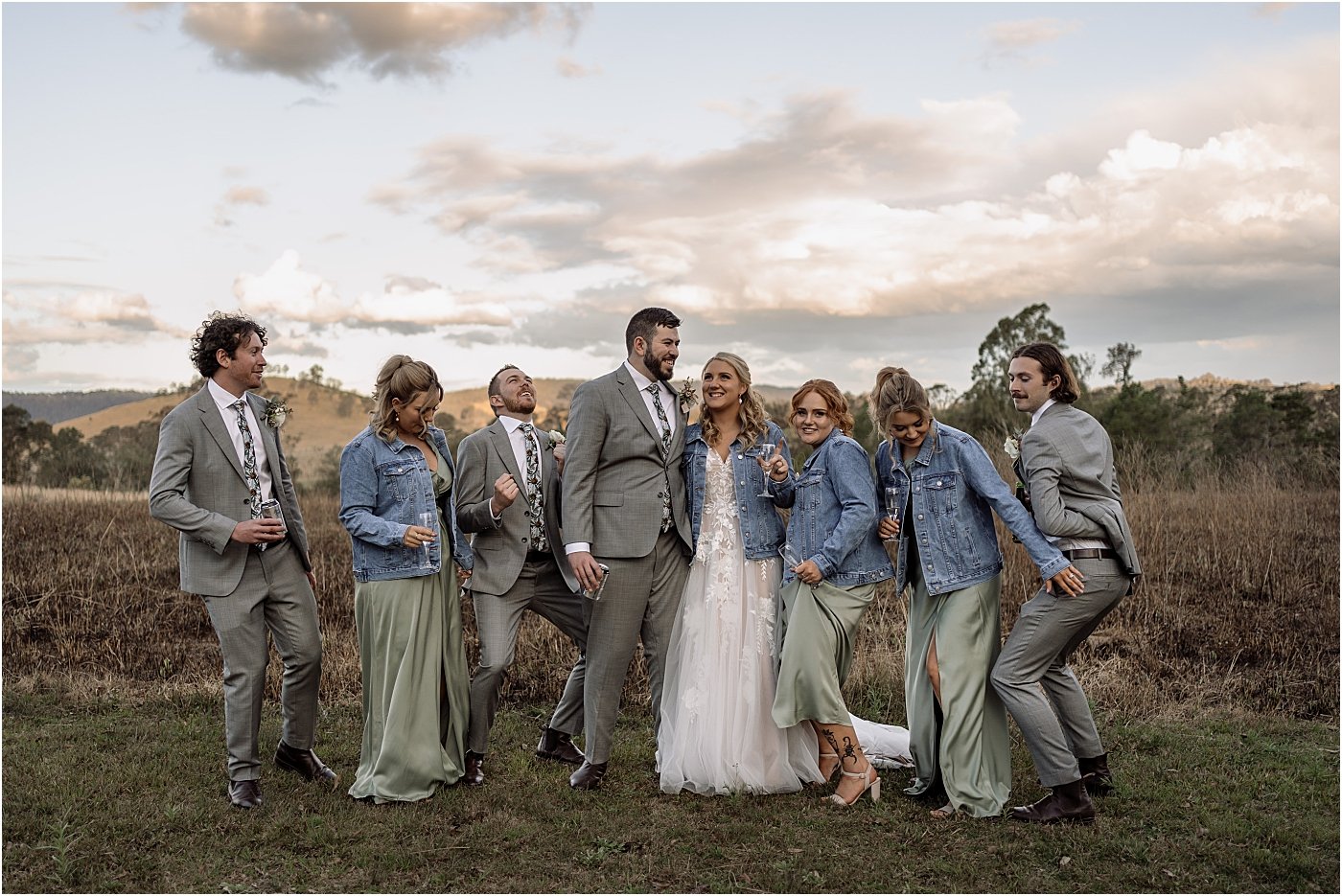 Bridal party dancing, with bridesmaids wearing matching denim jackets