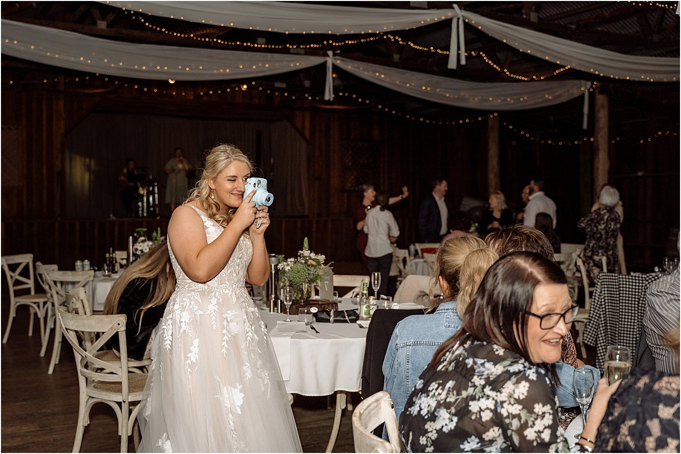 Bride taking an instax photo of her guests at her wedding