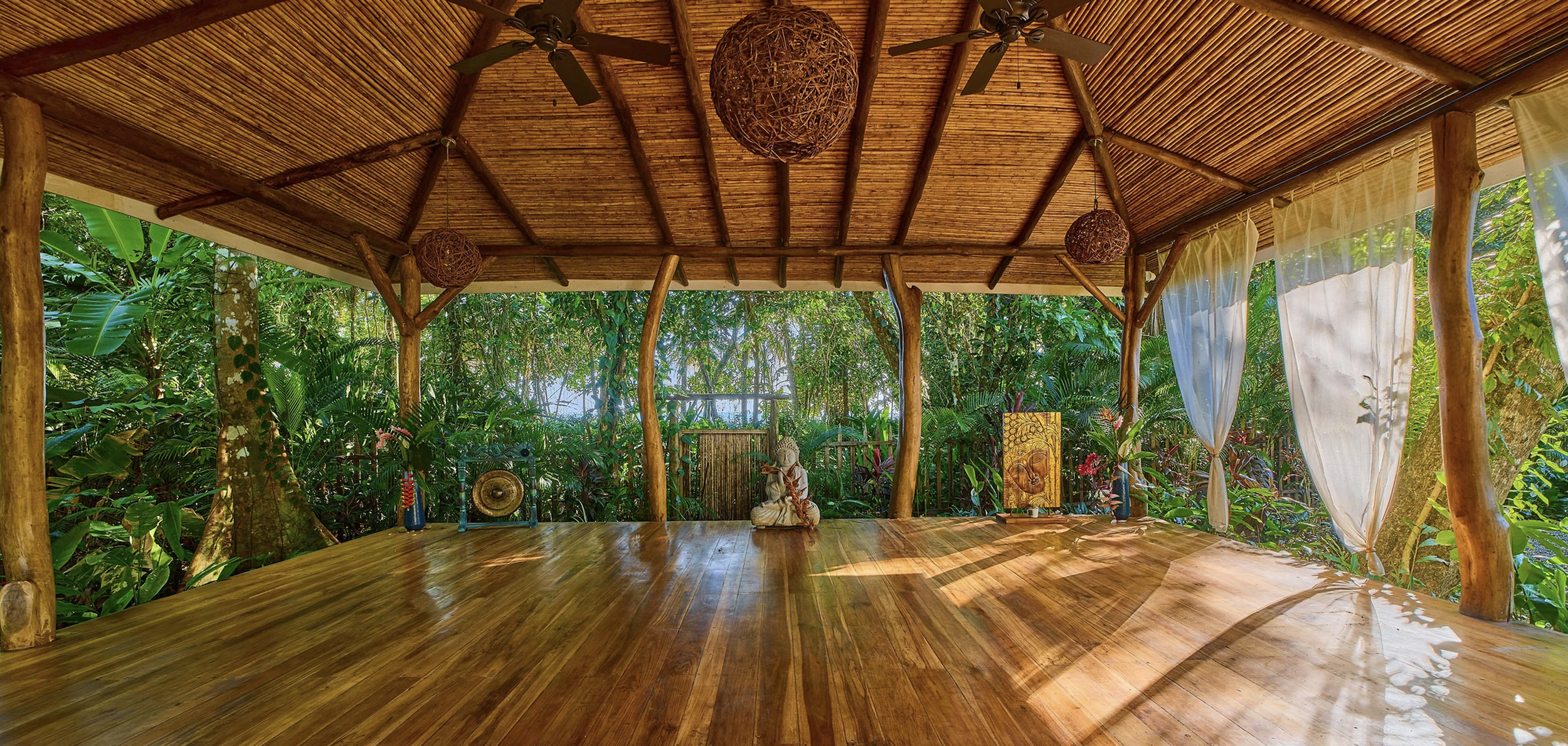 Dragonfly Yoga Shala - Open-air meditation space with wooden floor and bamboo ceiling in Punta Uva, Costa Rica
