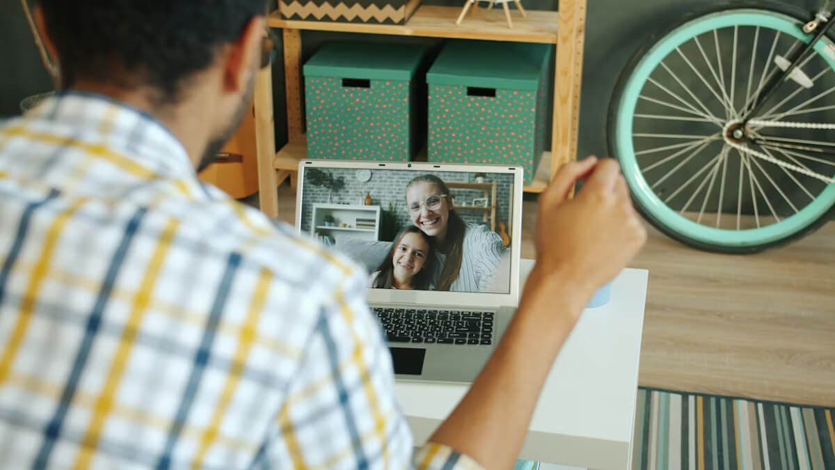 Man  having video call with woman and child