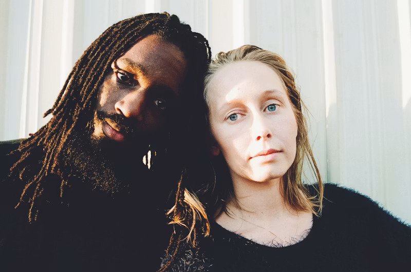 Couple looking tired at camera