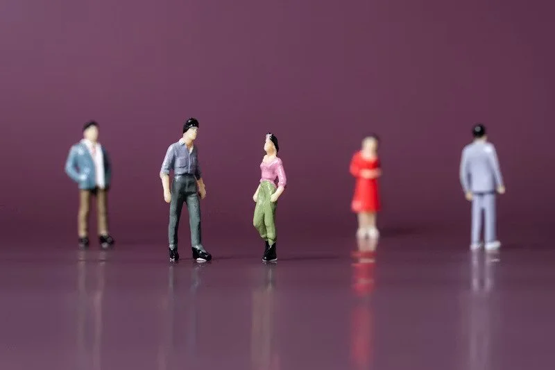 Five people figures to represented adopted adult, partner, and family members