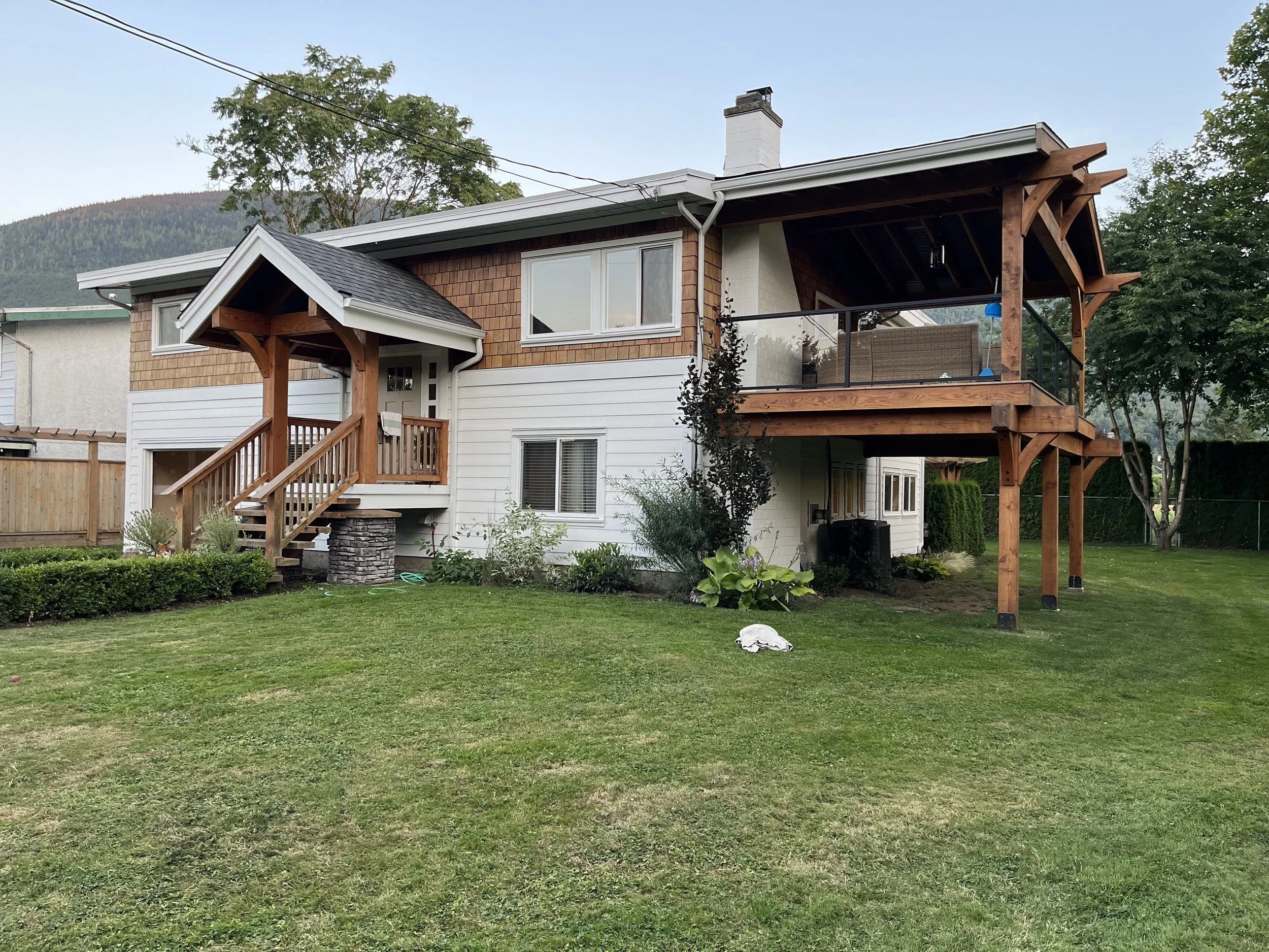 Chilliwack exterior repaint with white walls and stained highlights