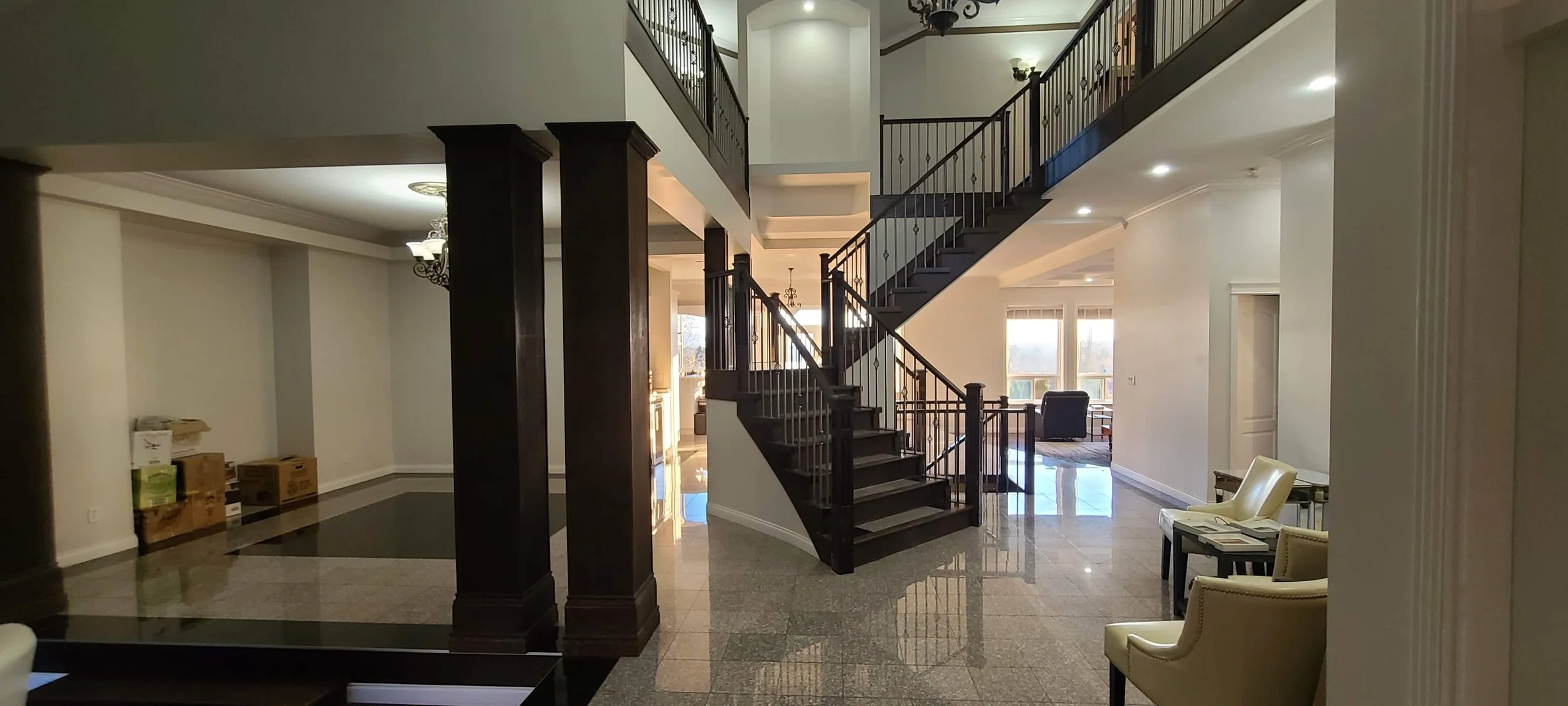 Beautiful stained stairwell railings in a large modern white house