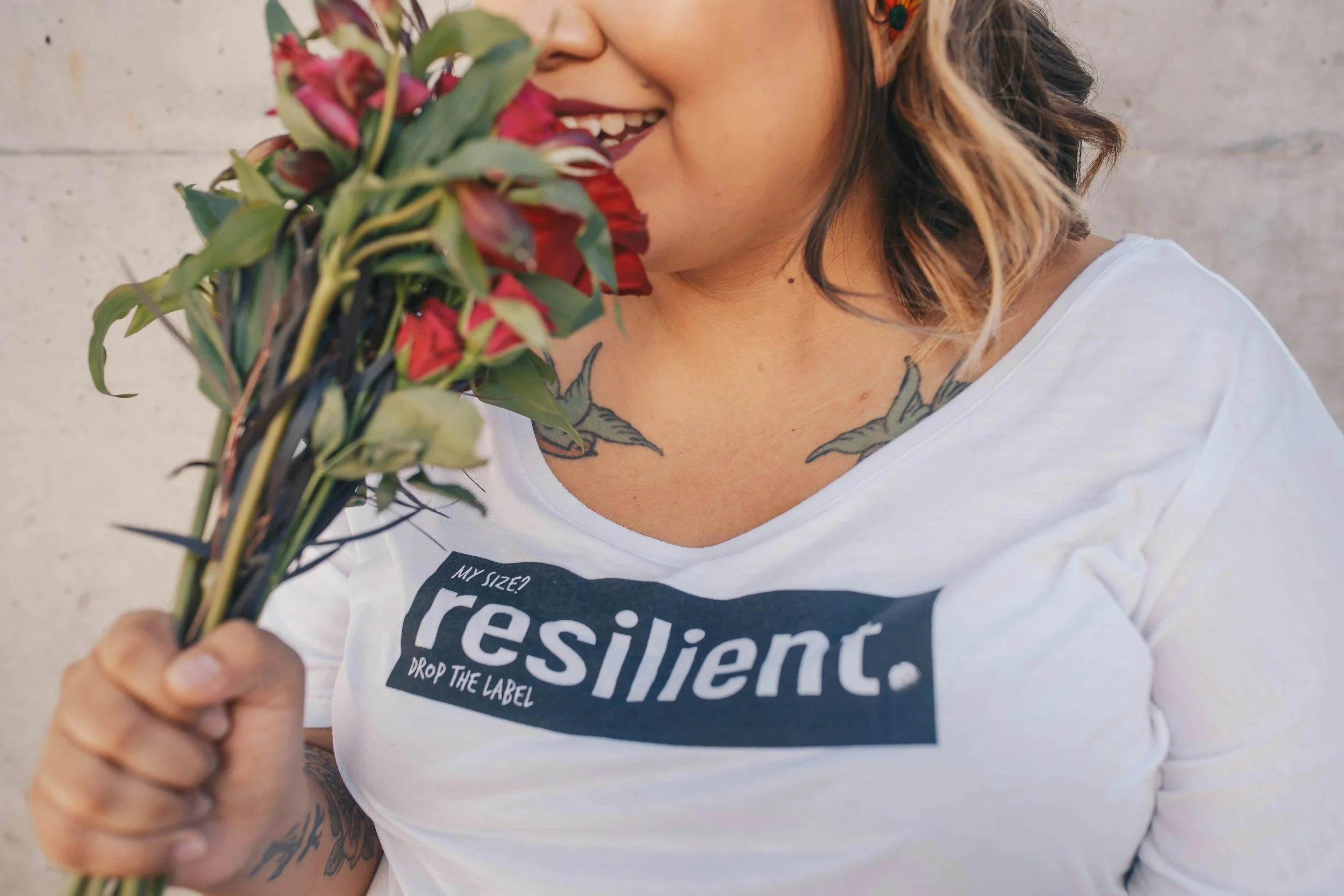 hispanic woman with lipstick holding roses feeling less alone and drained by emotions and relationships