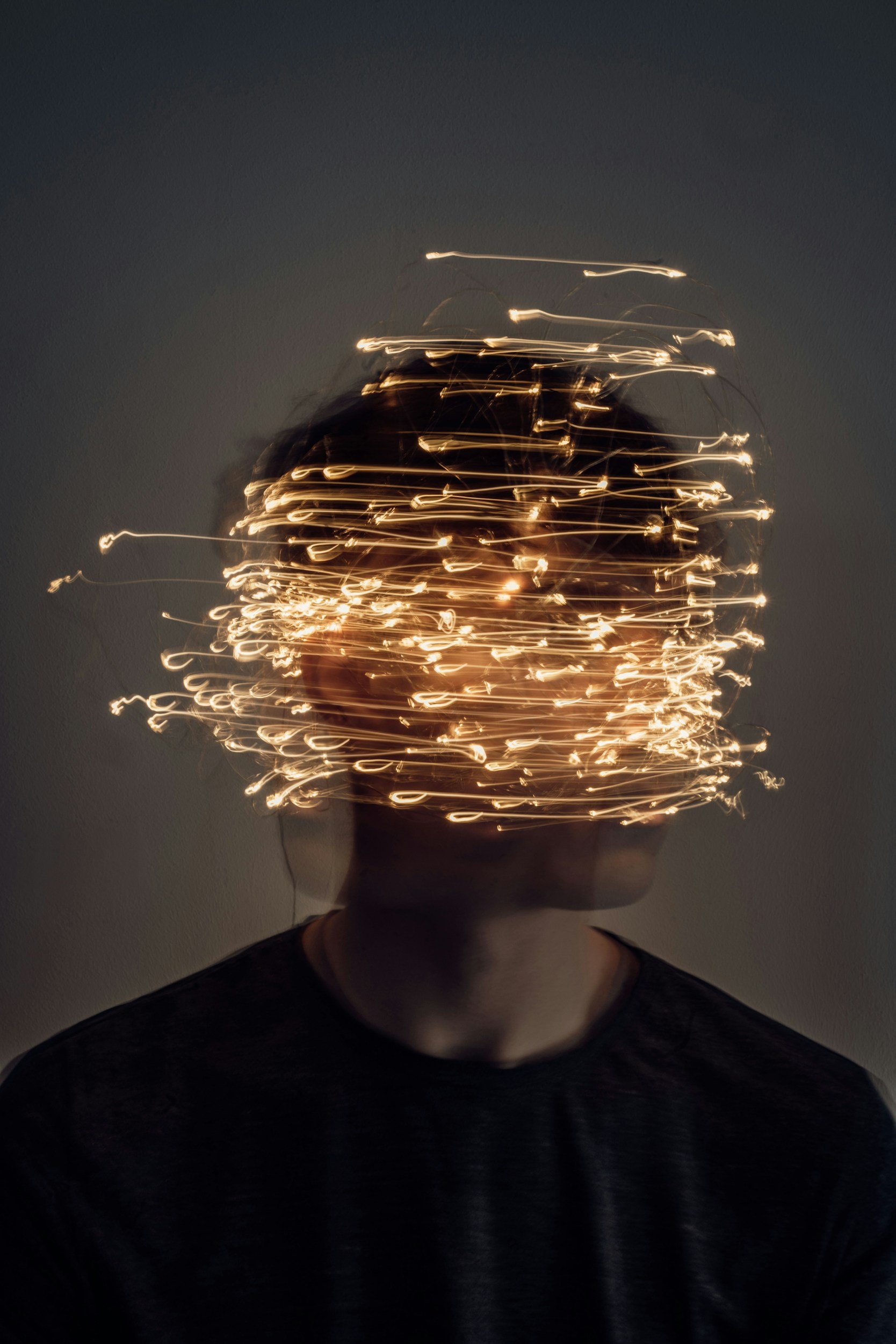 image of BIPOC adult with lights over head symbol of decision making anxiety in anxiety therapy Los Angeles CA