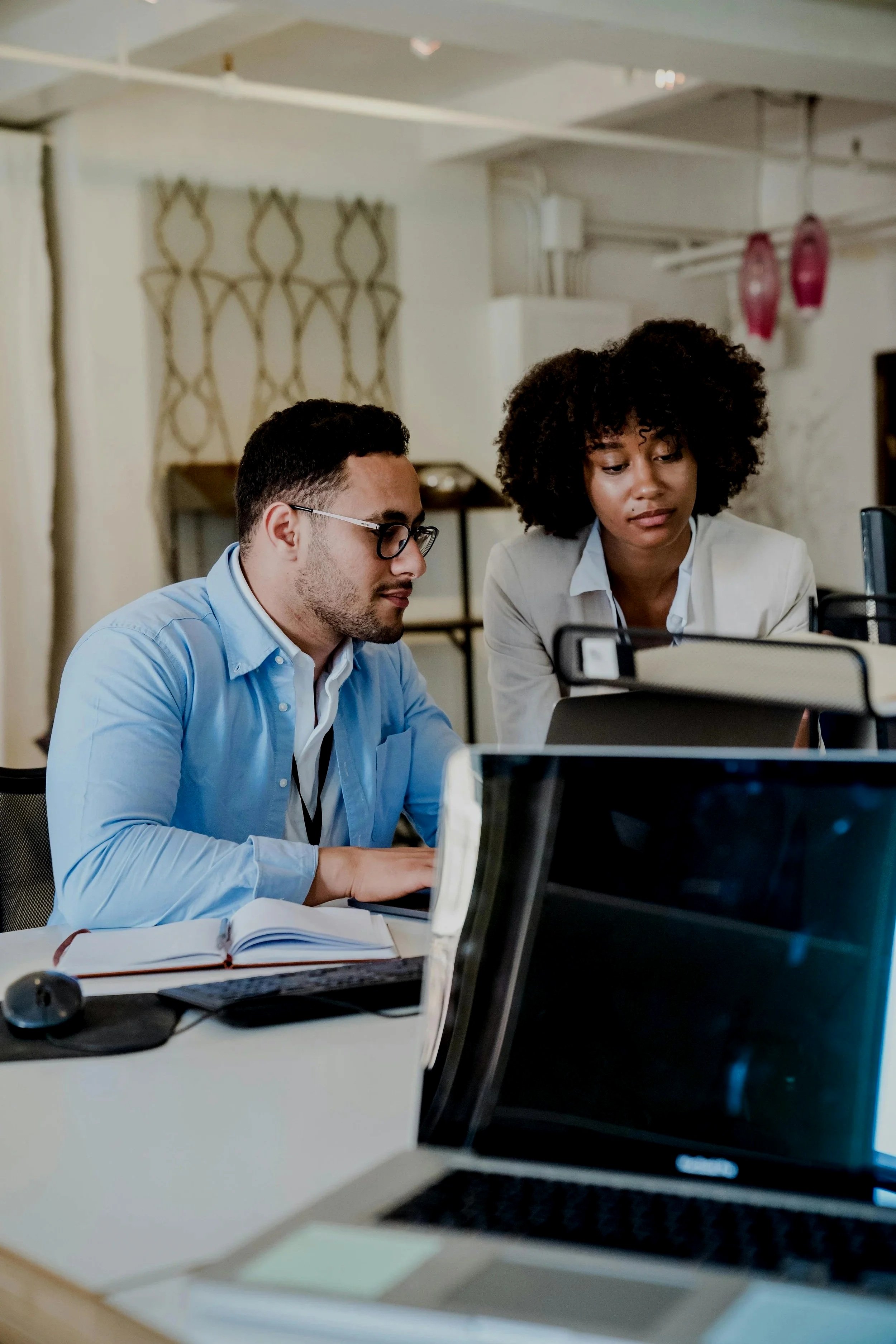 man and women looking at computer