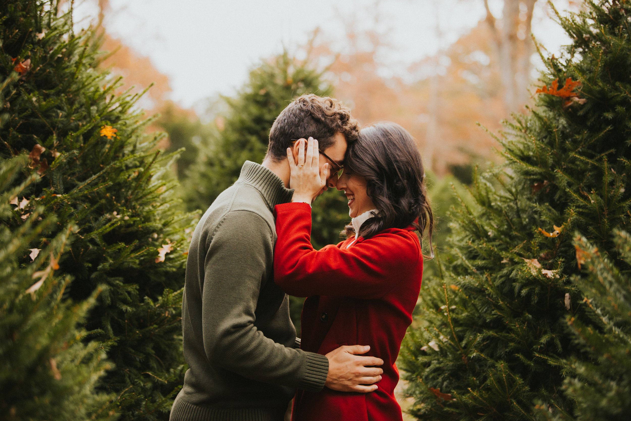 Couple Embracing in Christmas Trees | Emily Goodwin Photography