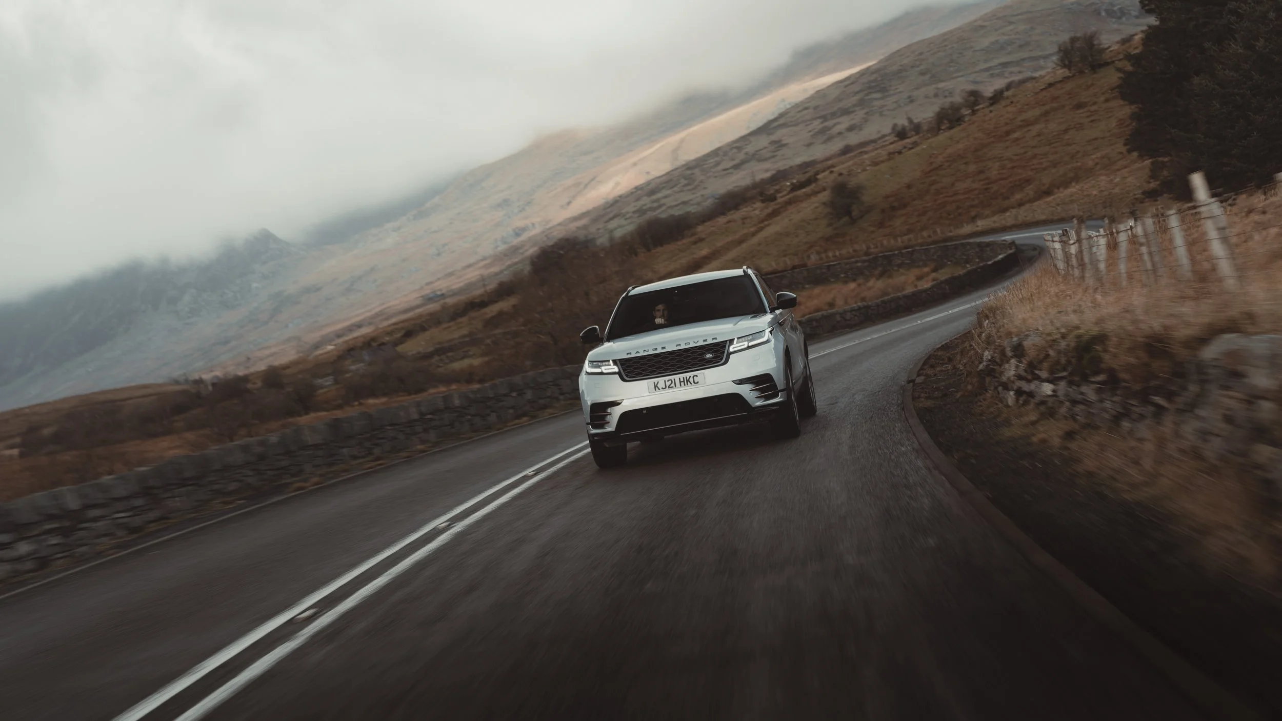 Range Rover driving along windy road in Snowdonia Wales, photographed by automotive photographer Rob Ash