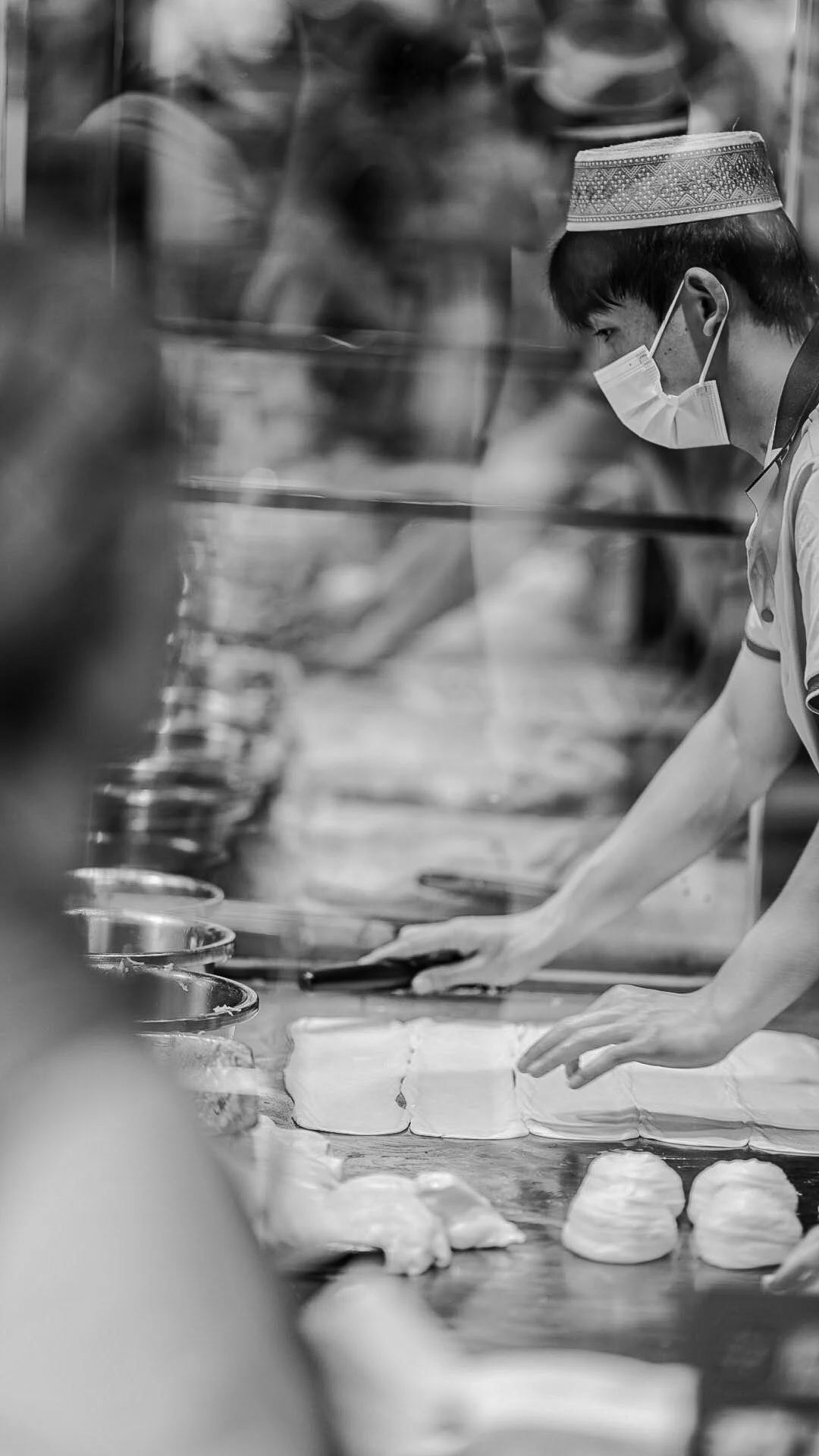 The Work
Chengdu, China
Across the street from our hotel, a line had formed along the sidewalk for buns being made by hand and passed directly to customers. The workspace extended out toward the street, with several people working side by side at the