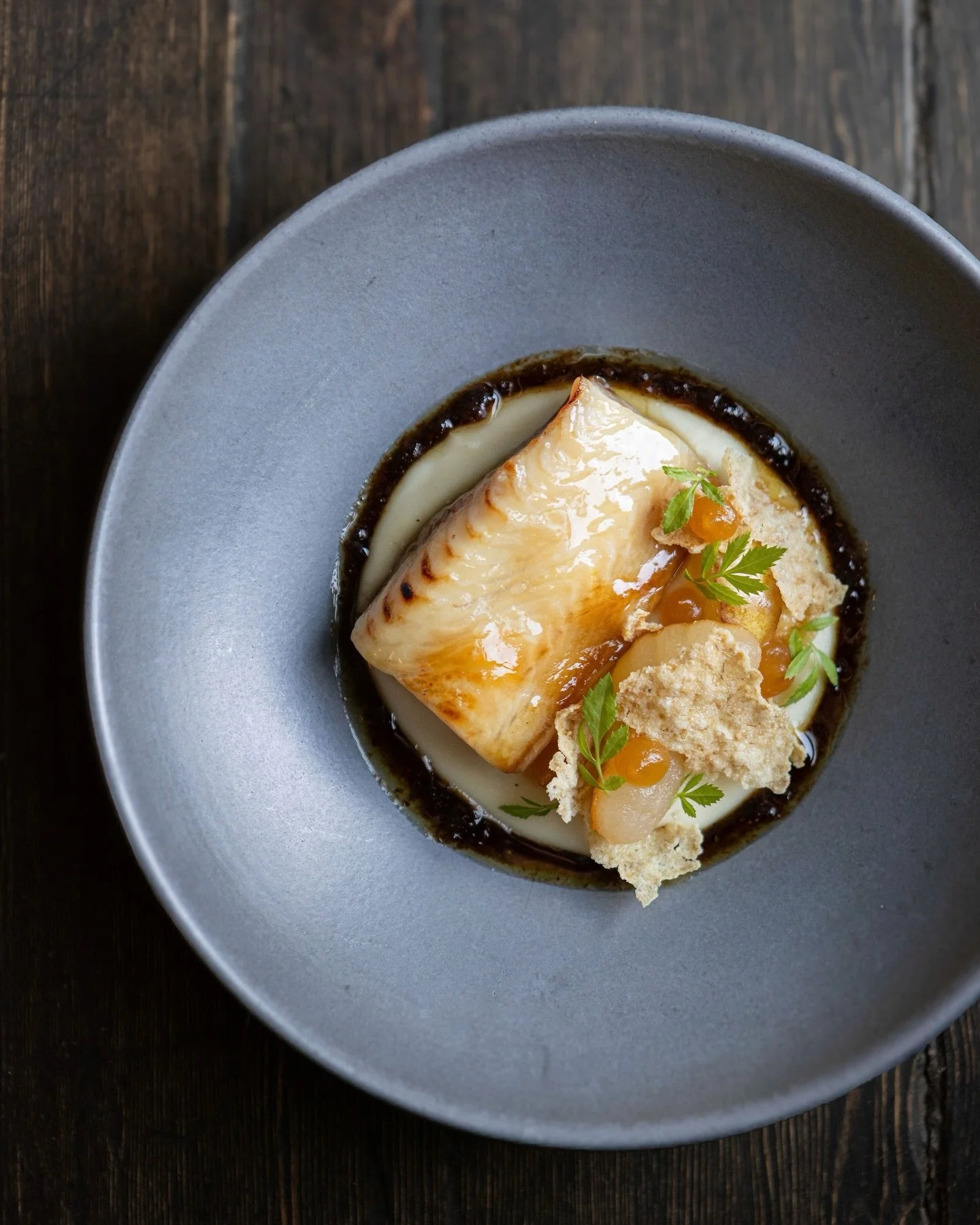 Kyoquot Sound Smoked Sablefish, Poplar Bluff Farm Parsnip and Pear Pur&eacute;e, Pickled Bartlett Pear, Highwood Crossing Oat Crisp, XO Sauce.
Our smoked sablefish begins its journey in the pristine, ice‑cold waters of Kyuquot Sound on Vancouver Isla