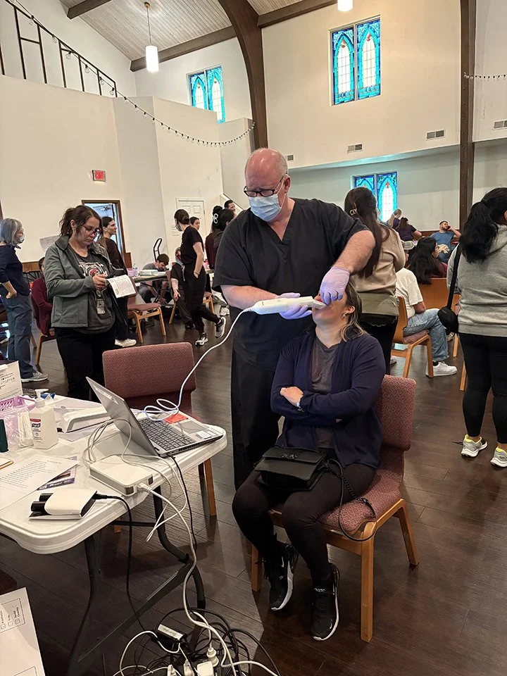 Dr Michael Rainwater scans a patient at a prescreening.jpg