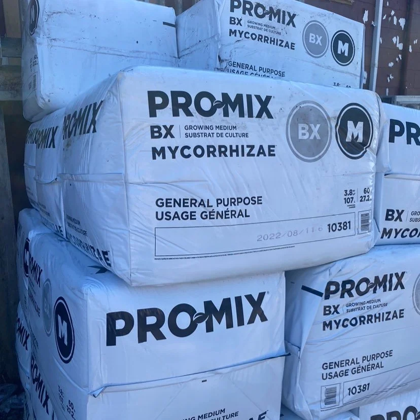 Bags of Pro-Mix BX Mycorrhizae general purpose growing medium stacked outdoors.