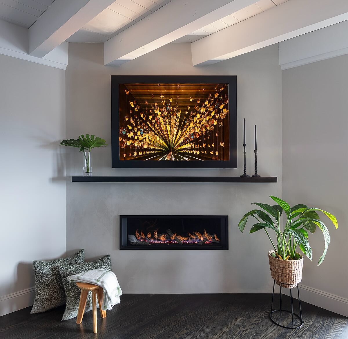 Imagine curling up by this warm, sleek and modern fireplace as you gaze at this enchanting art piece of dancing butterflies by Jocelyn March. 

Swipe left to explore the before pictures of the dated mantle and see the process of how our team transfor