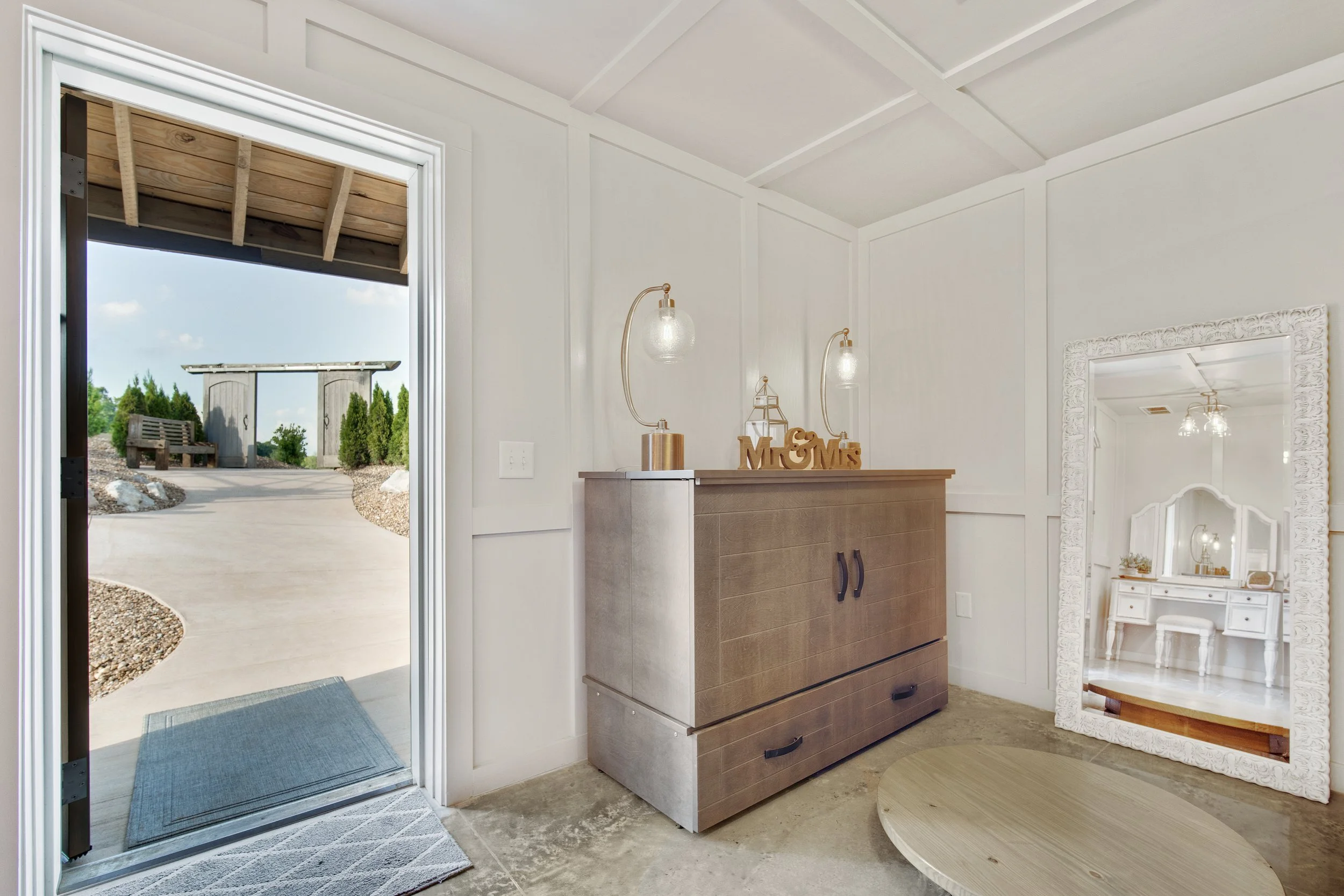 Tennessee wedding venue bridal suite has a door that opens to paved path, wooden privacy doors to hide the bride on her way to the aisle.