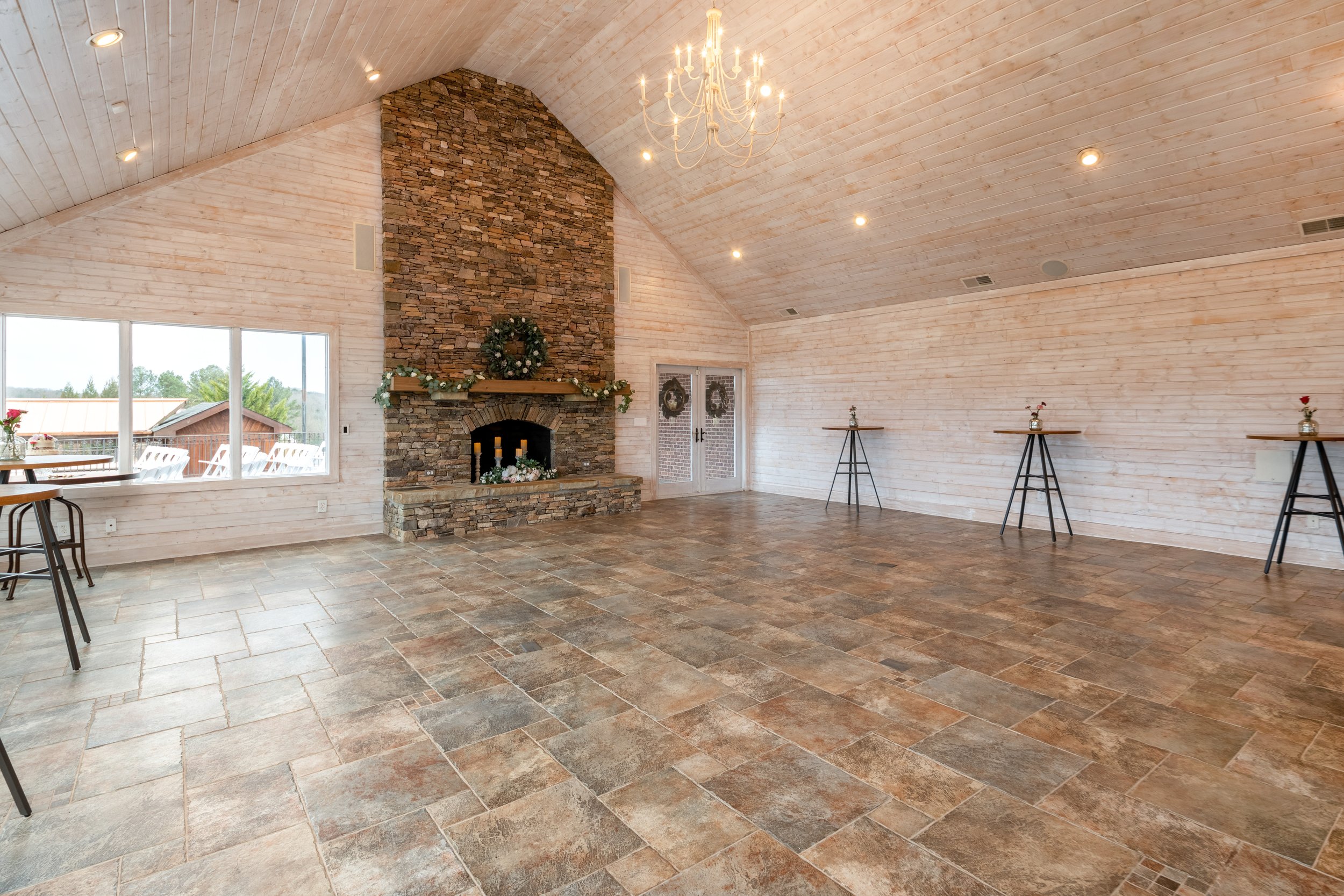 Reception Space at the Ridgeview Terrace is an intimate venue with cozy ski-lodge vibes, large fireplace, windows.