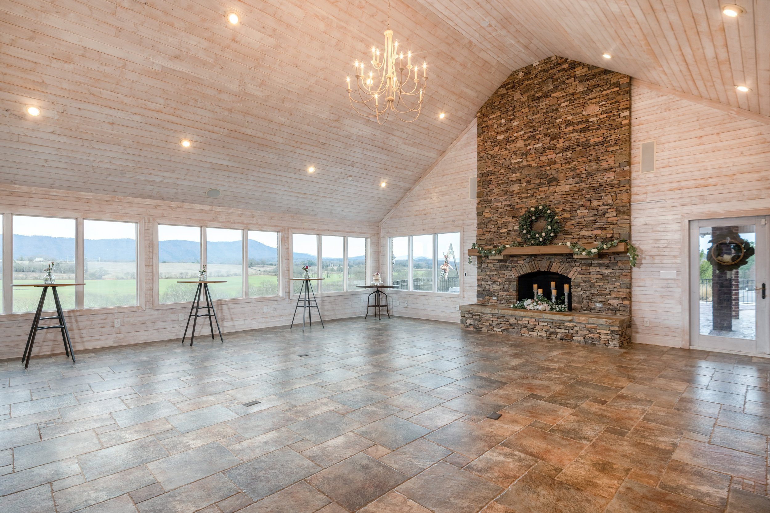 Intimate wedding venue in Eastern Tennessee, Ocoee Crest. Large fireplace focal point, windows overlooking mountains.