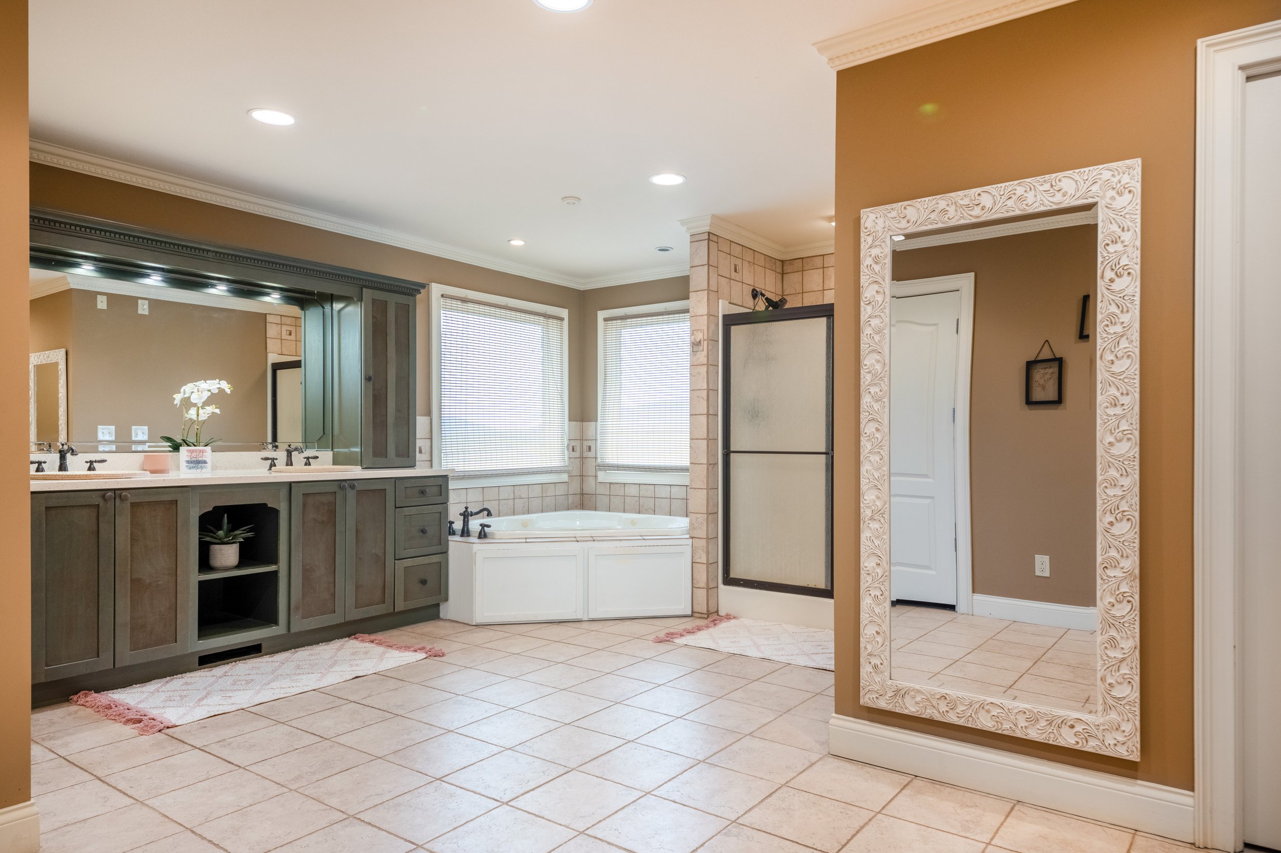 Bridal Suite Bathroom, generously sized with huge full-length mirror, large vanity, and tub.