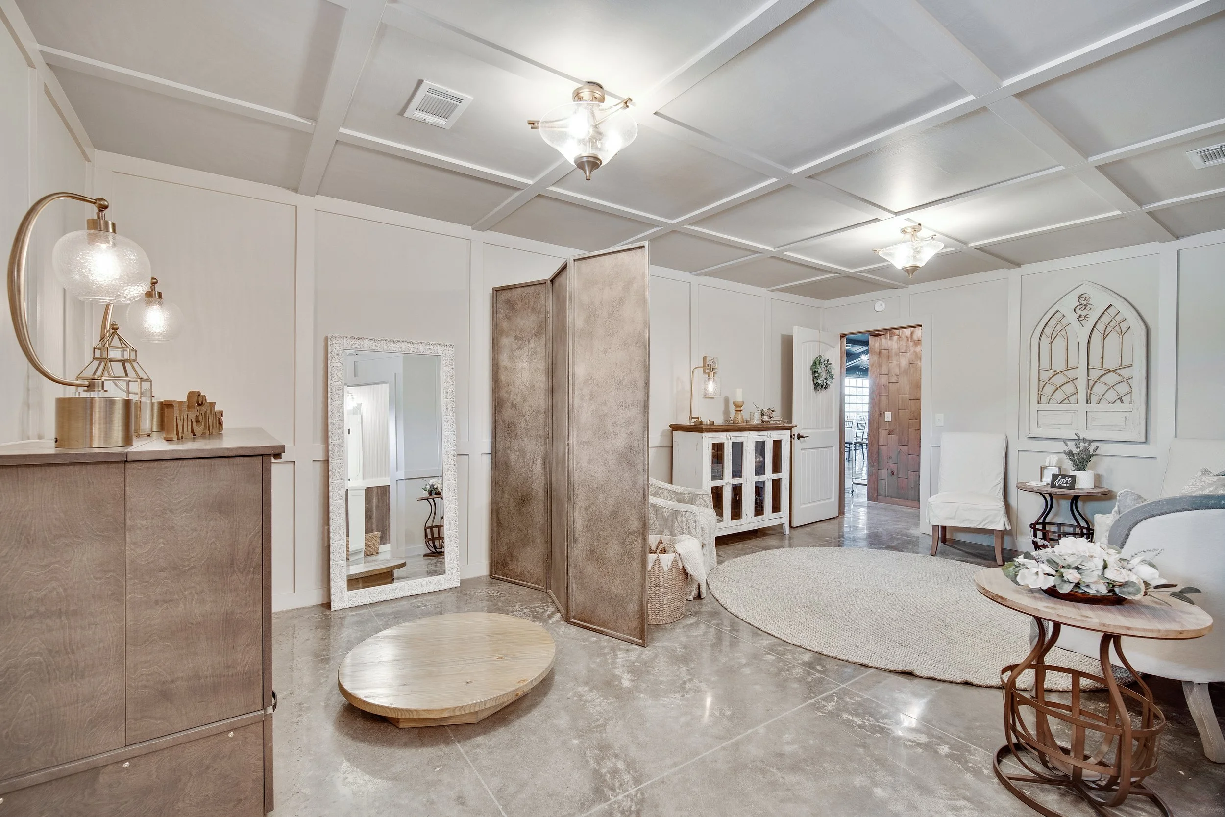 Ocoee Crest Bridal Suite includes bright light, white walls, large mirror, privacy screen, seating.