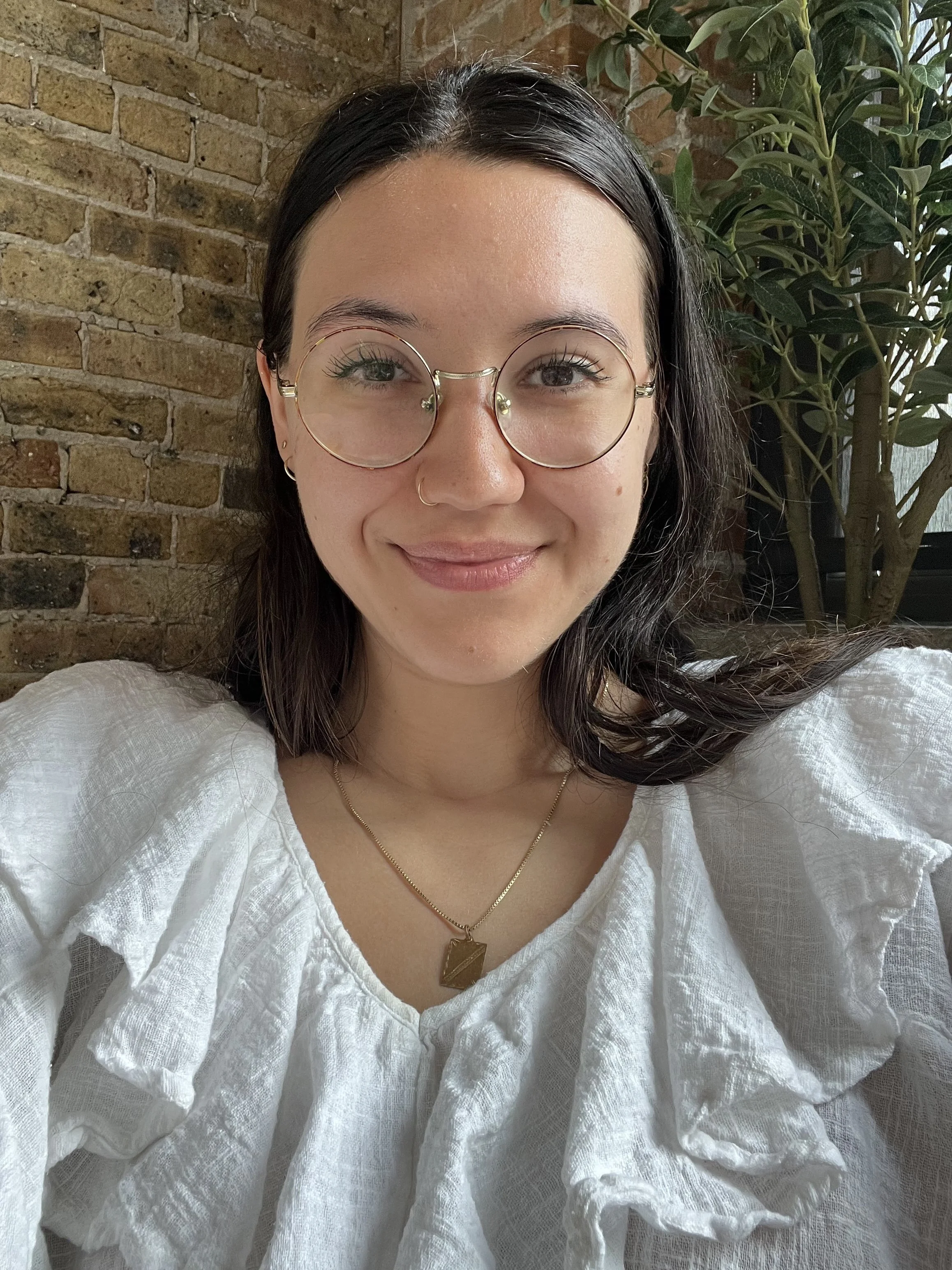 Headshot of therapist Neila Ouldali smiling at camera.
