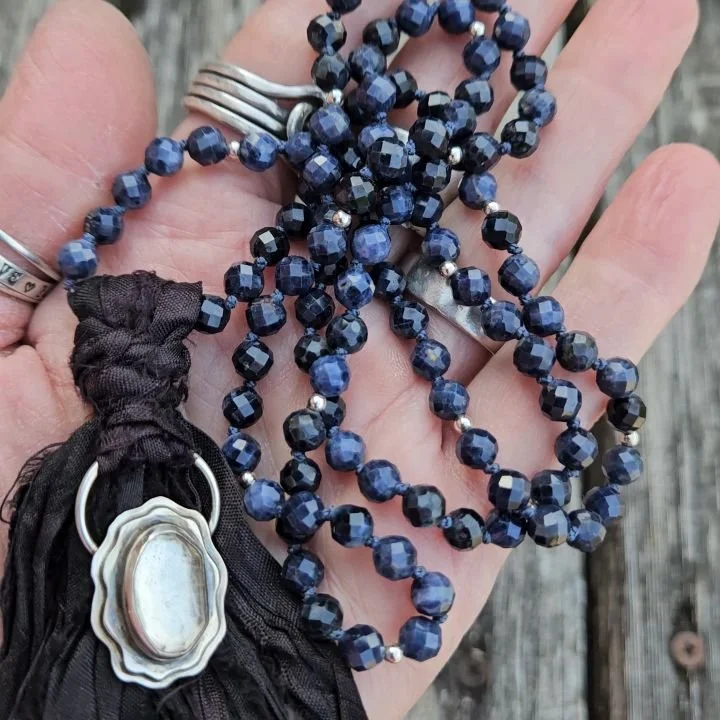 The Blues.....
A Blue Sapphire mala with a incredible Blue Moon Crystal pendant. Hand knotted and highlighted with sterling silver beads. Don't you just love that sparkle? A silk tassel is such a perfect compliment to it all.... and I did include a m