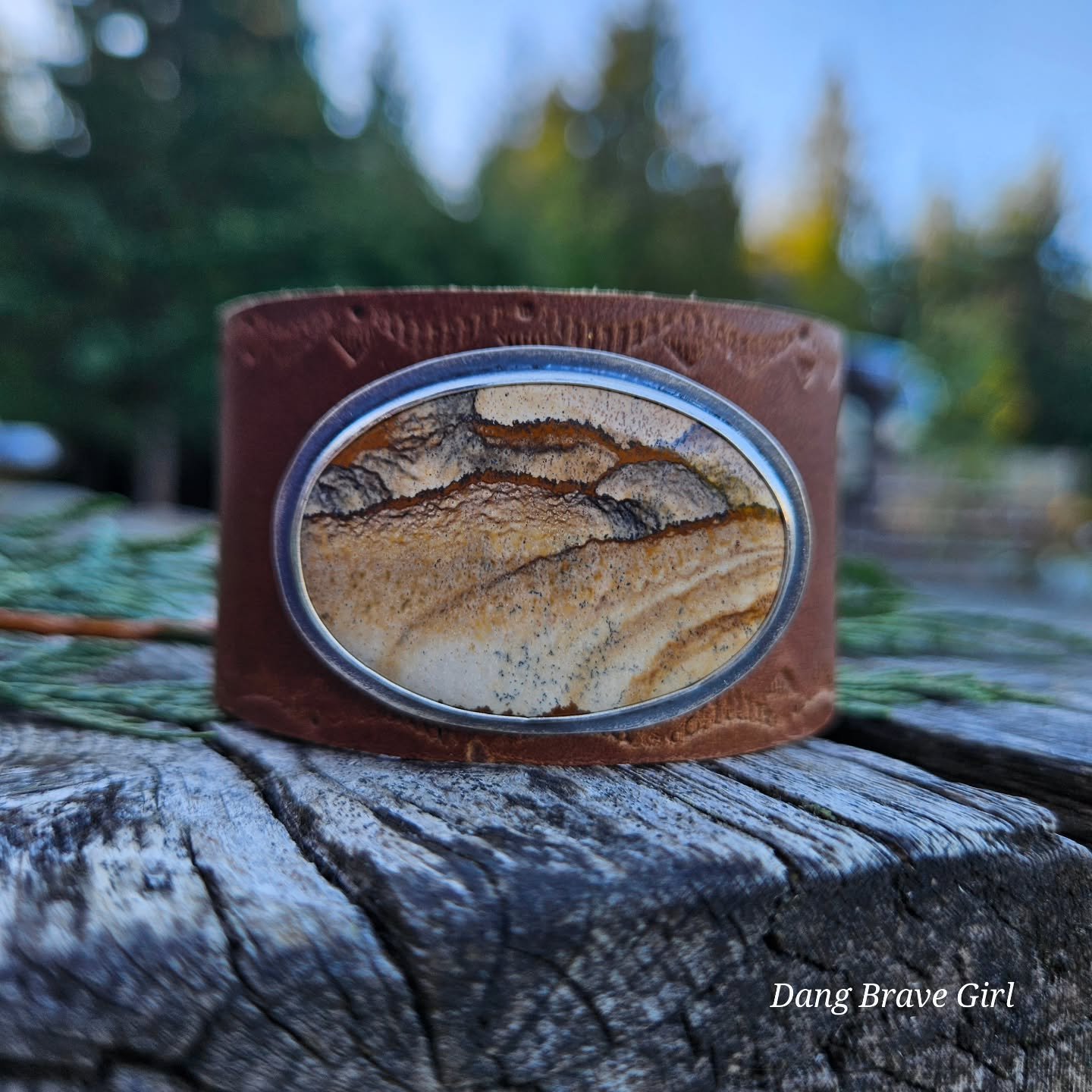 For the Mountain Mama ⛰️....

This exceptional chunk of Picture Jasper sits majestically in silver, on a complimenting brown leather that has been subtly stamped in the background. 

It has adjustable sizing and is ready for your next adventure ⛰️.

