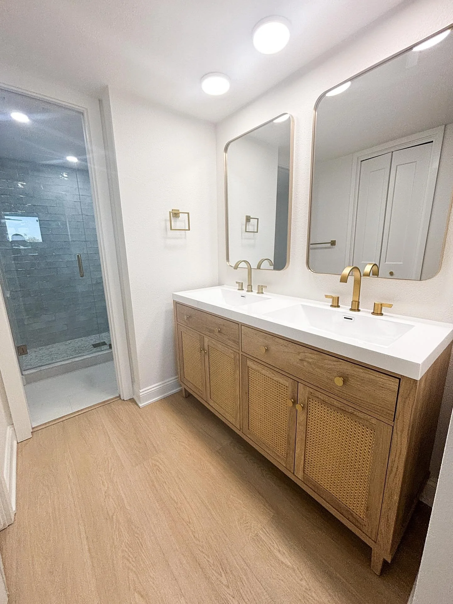 Designed with the coast in mind.
Natural wood cabinets, ocean toned tiles, terrazzo shower floors, and brushed gold details create a space that feels both relaxed &amp; elevated.