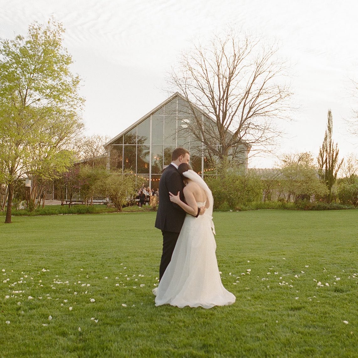 Kendall &amp; Will sharing a quiet moment together while guests mingle at cocktail hour in the background 💛