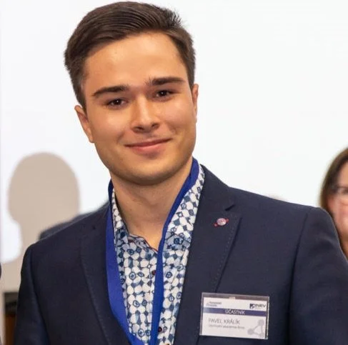 Young man in a suit with name badge at a conference