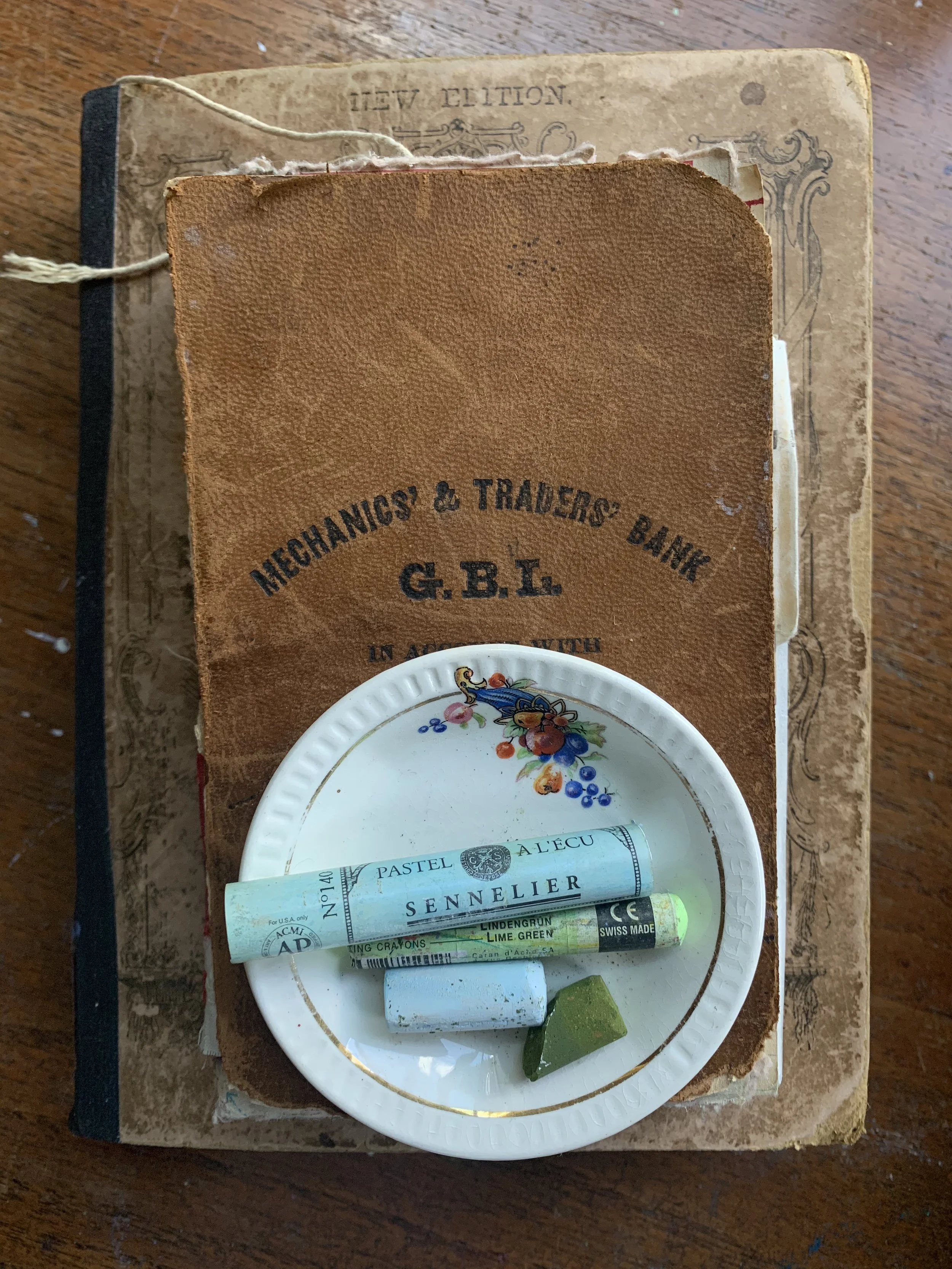 Vintage art journal and a small paint holding pastels.