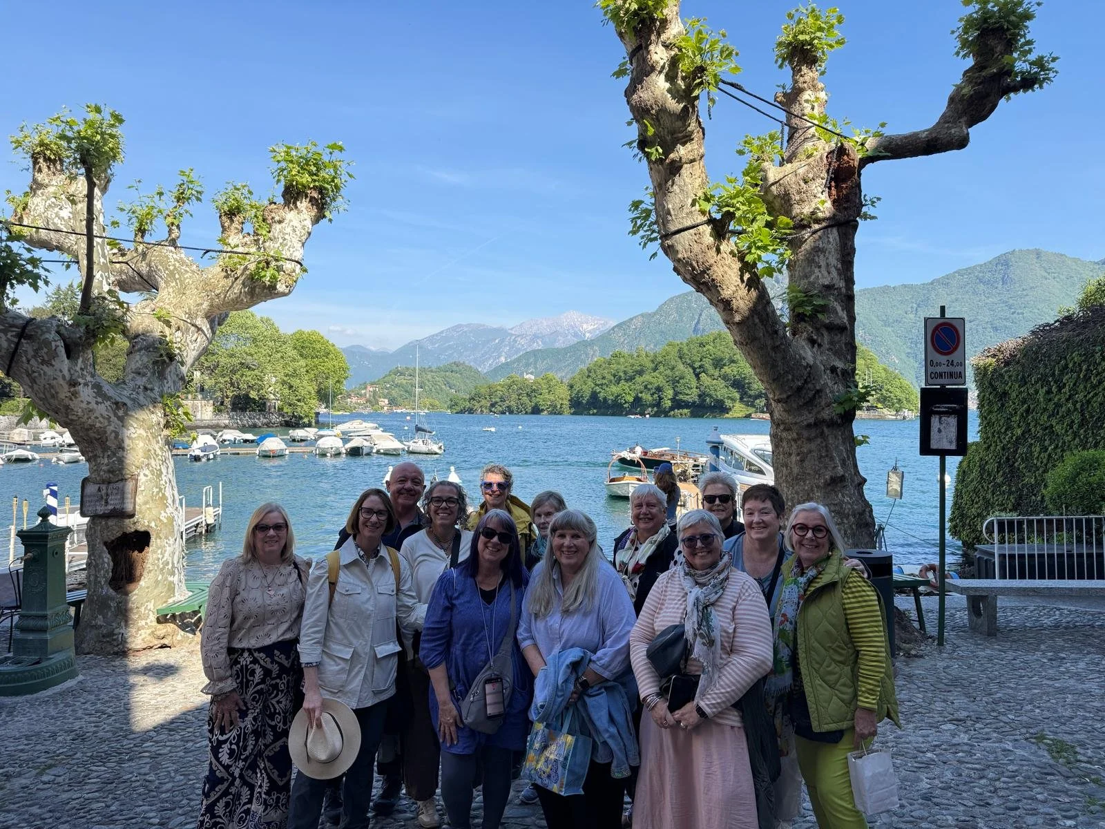 Travelers who have been sharing completed journals during a farewell luncheon on Lake Como.