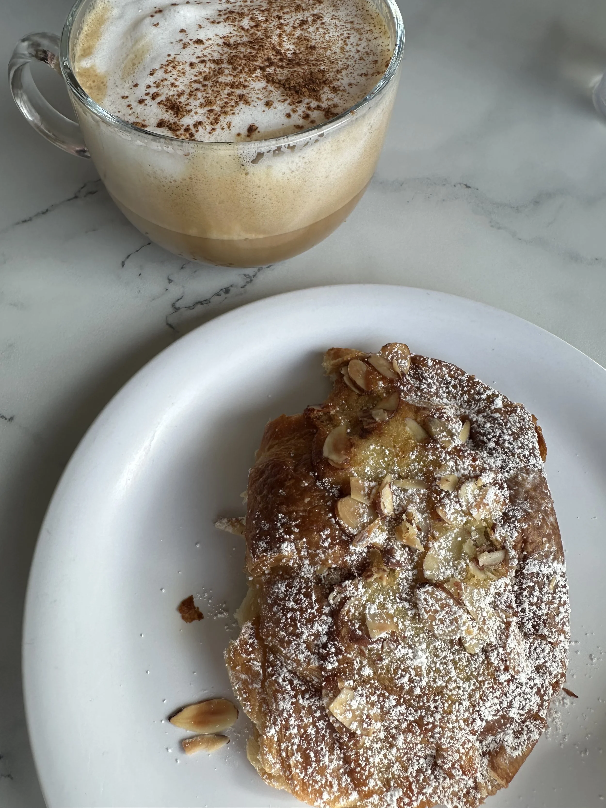 Cappuccino and cream-filled cornetto enjoyed during a morning in Lake Como.