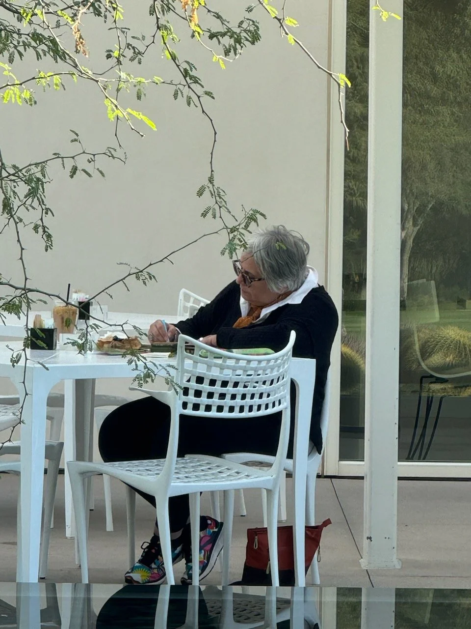 Me sitting at patio in Palm Springs working on my art journal.