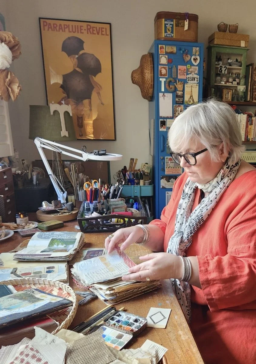 Tammy Gilley creating layered art journal pages in her studio