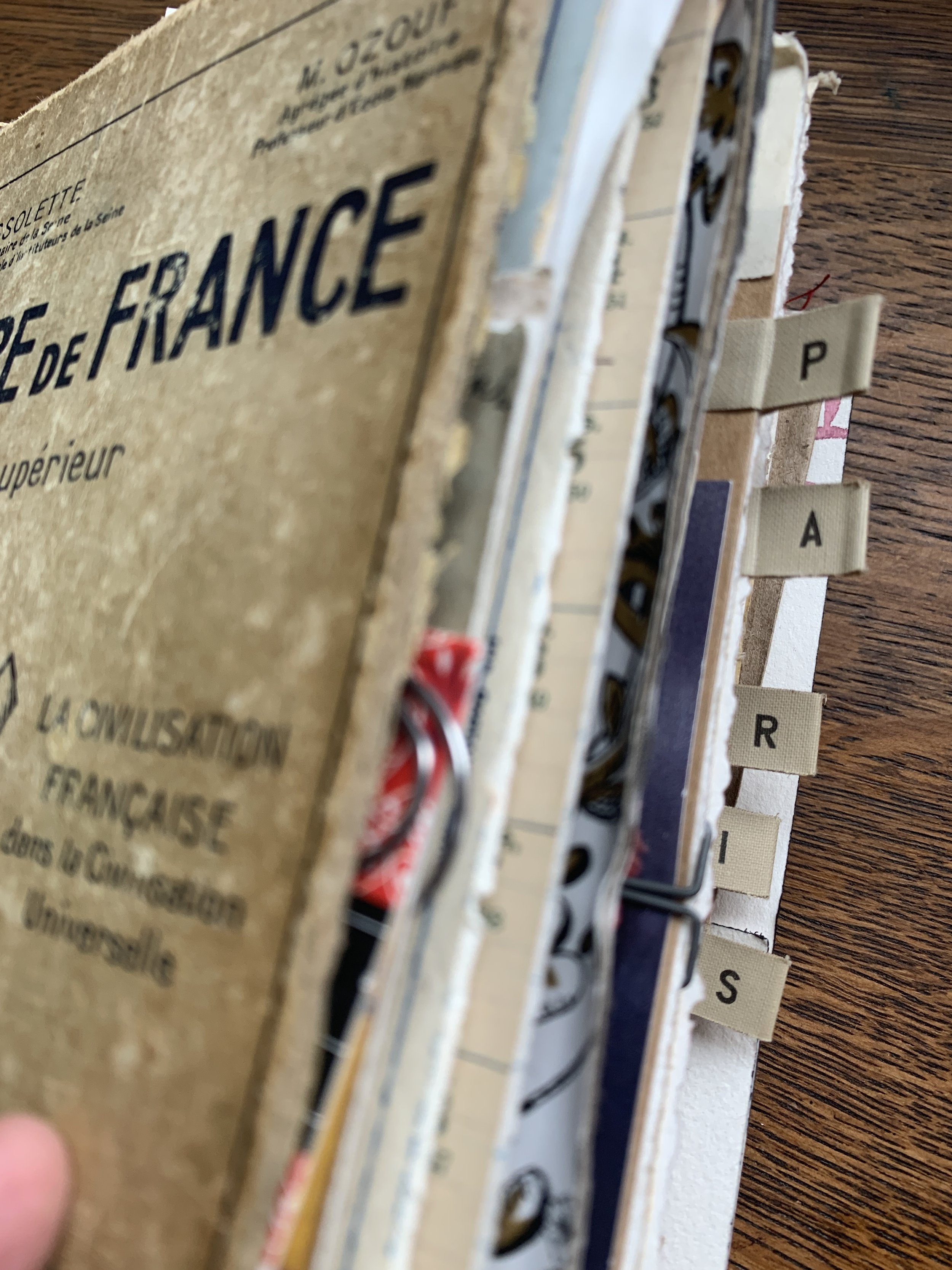 Vintage travel journal collage page with Paris ephemera, layered papers, handwriting, and travel memories.