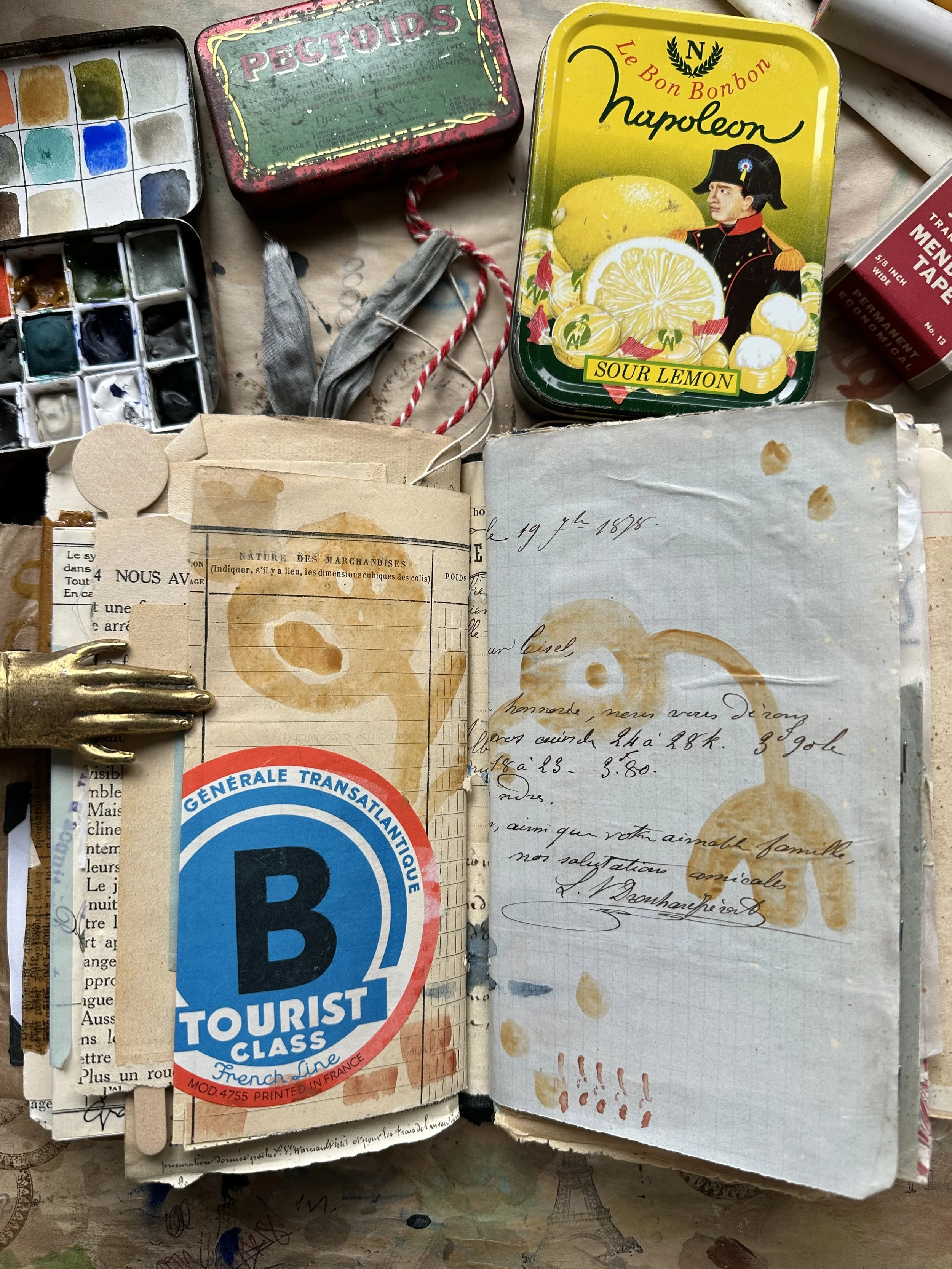 Handmade travel journal page with sketches, handwritten notes, and layered papers documenting a travel memory.