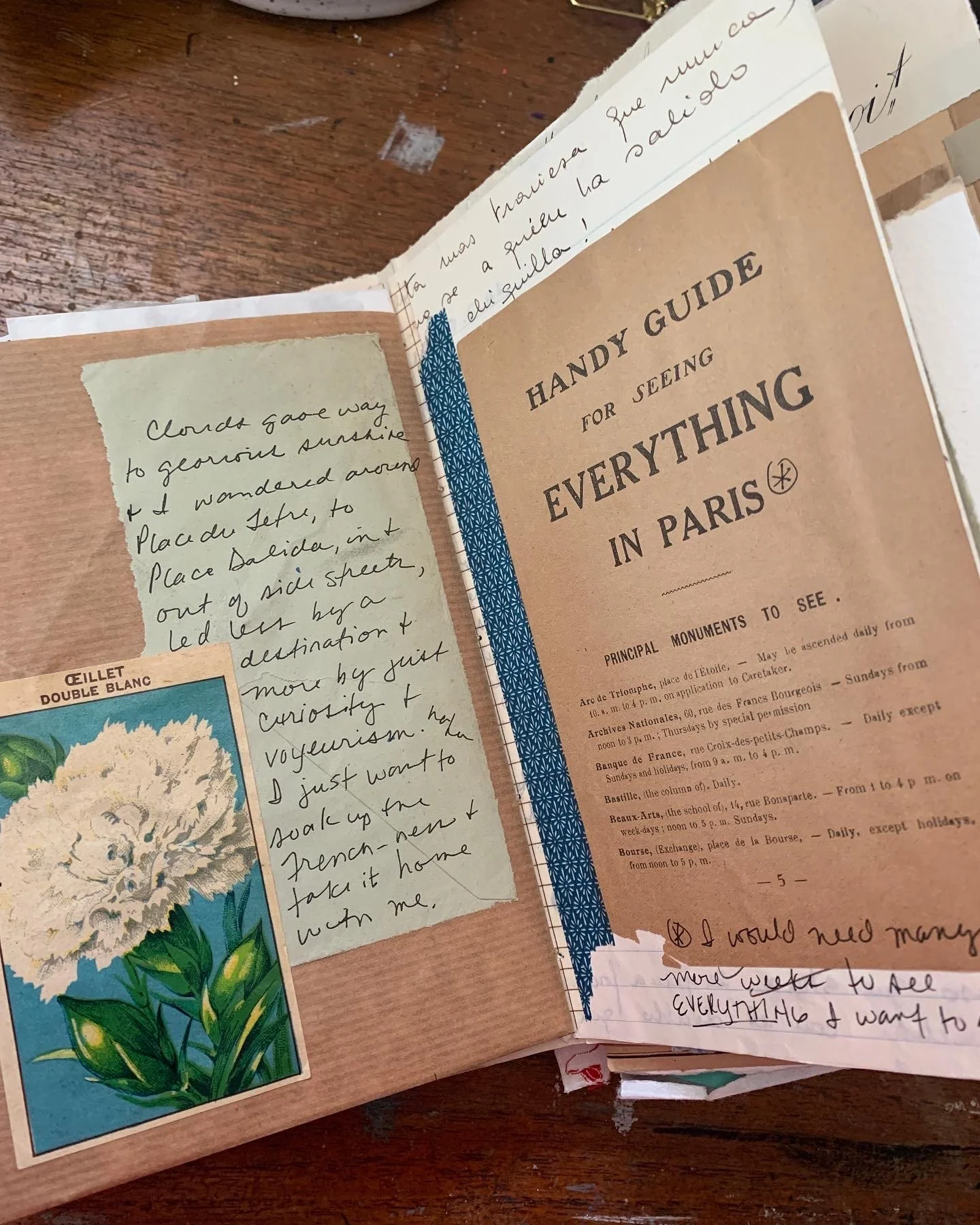 Open vintage travel journal showing layered collage pages filled with travel ephemera and handwritten reflections.