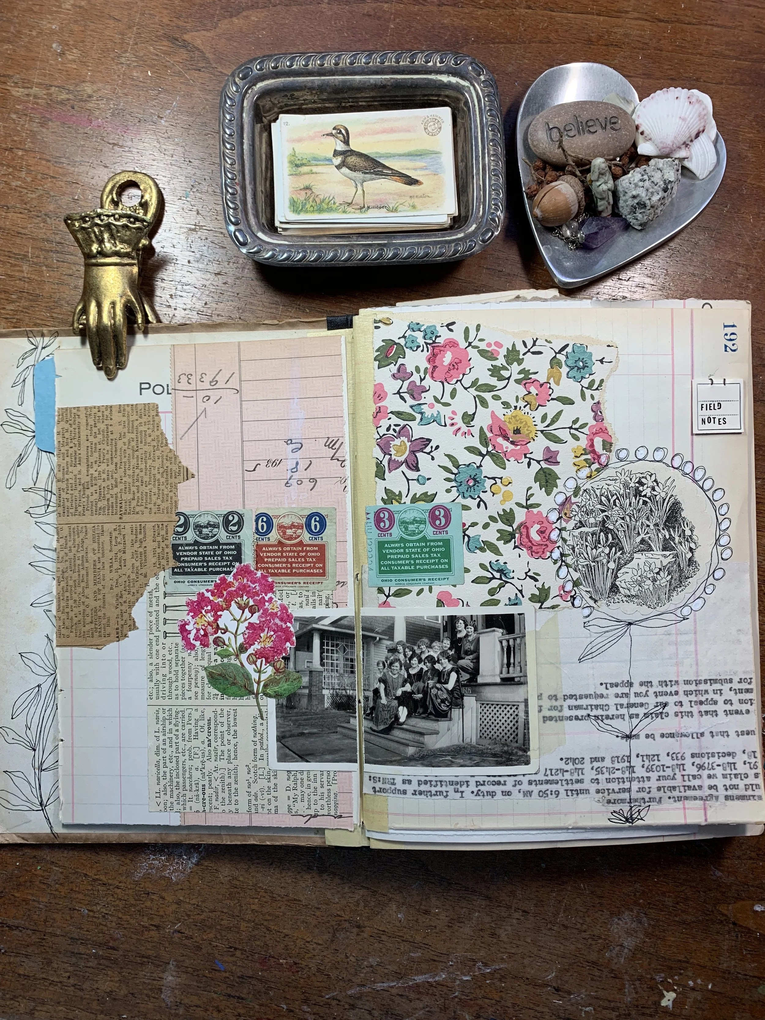 Close-up detail of a handmade art journal collage page with layered papers and textured ephemera.