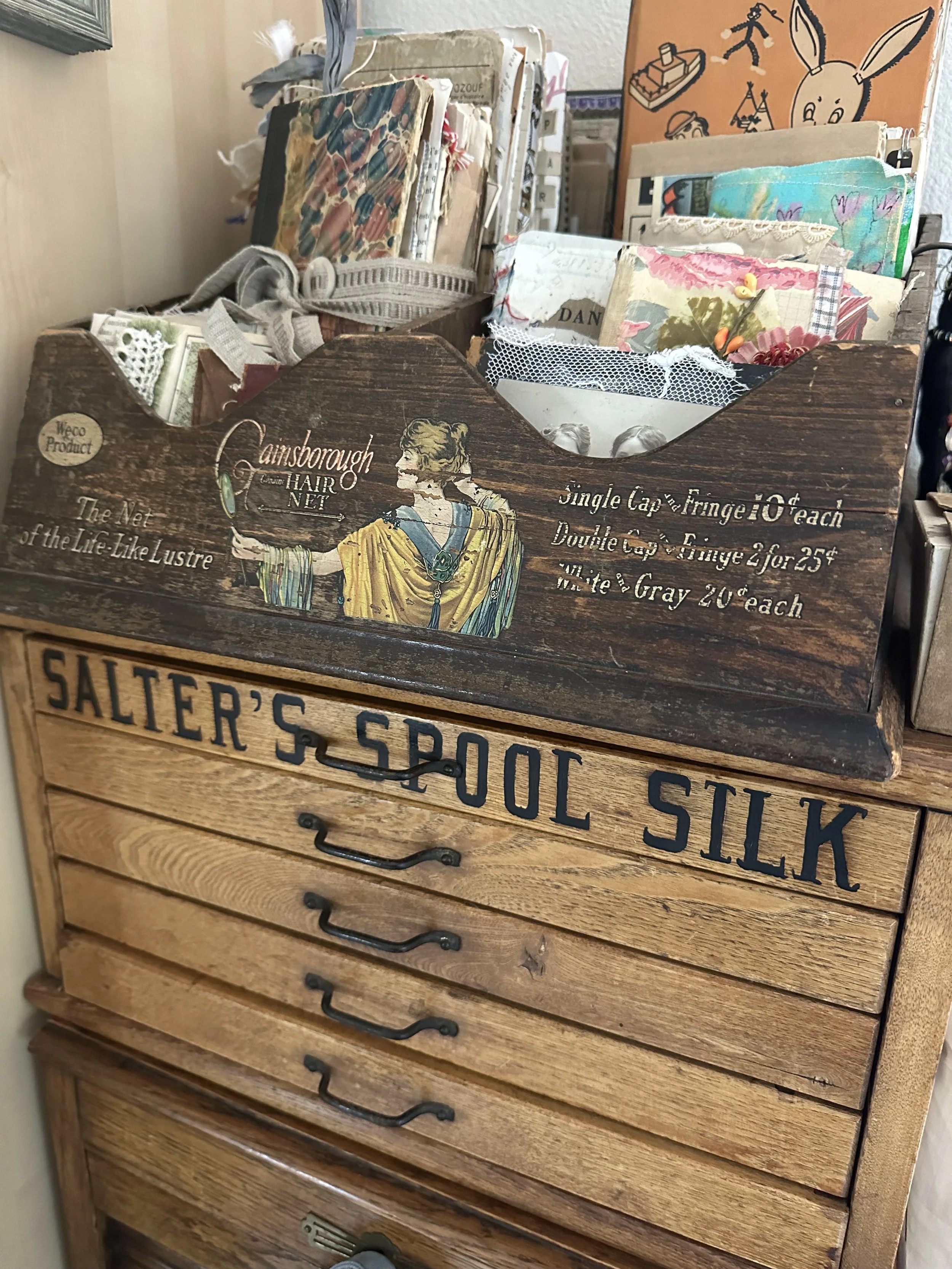 Creative workspace with vintage papers, journals, and collage materials used for travel journaling.