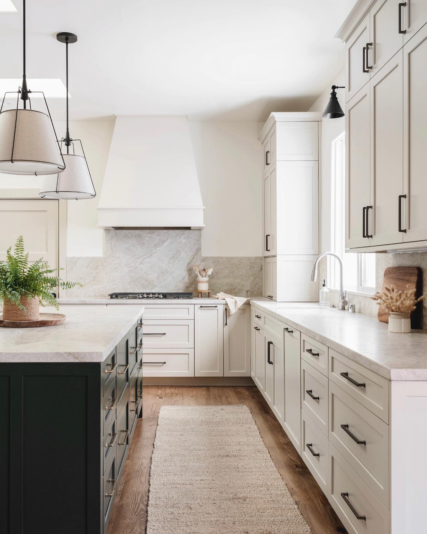 Are two-toned kitchens still a thing? We think so! In this beautiful kitchen, we opted for a soft putty color for the perimeter cabinetry and then accented with a deep green. We kept countertops the same since that color change was enough pop! Design