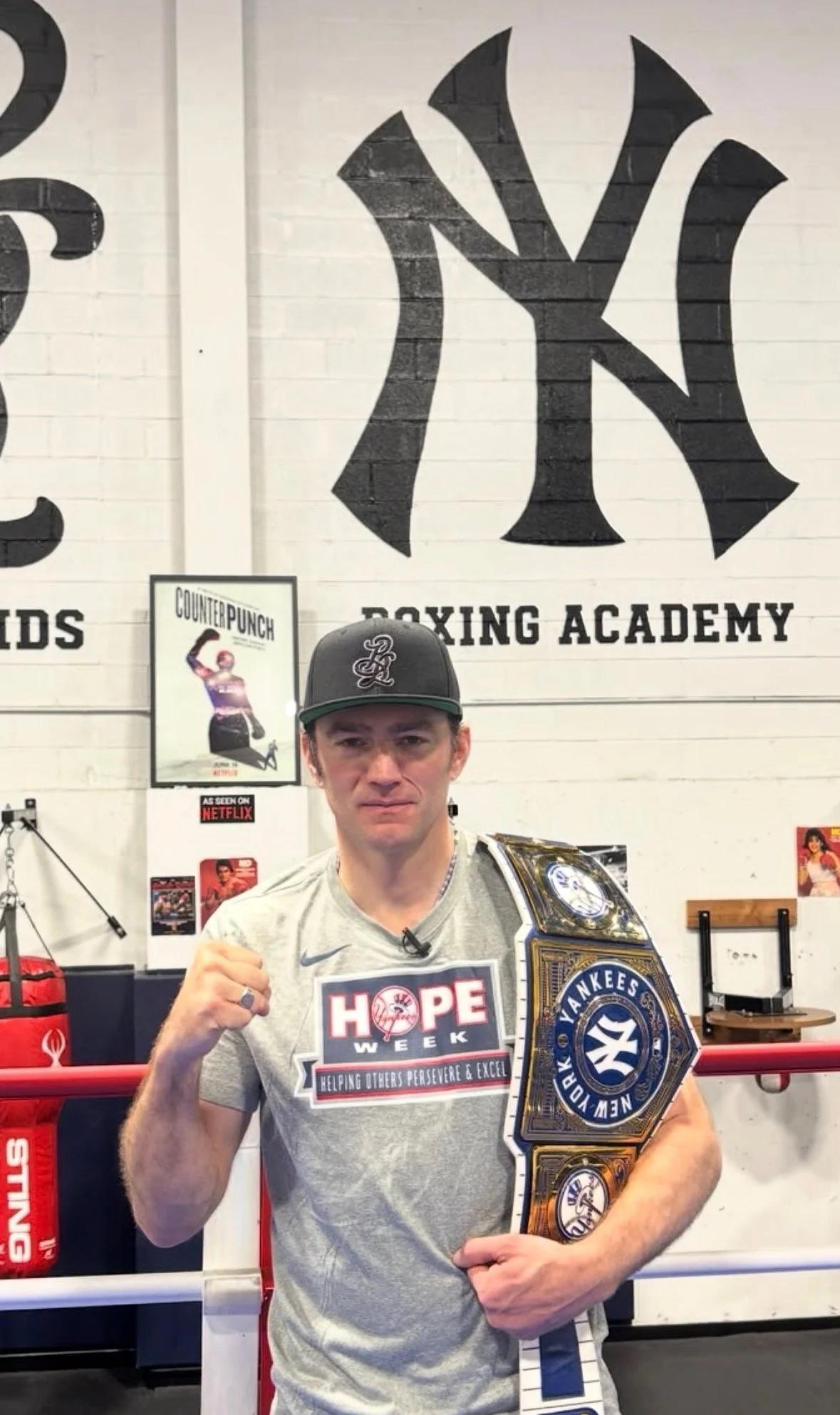 Jay Bulger holding a Yankees championship belt at Bronx Legends Boxing Academy