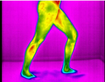 Infrared thermal image of a person's legs and lower body in a wide stance.