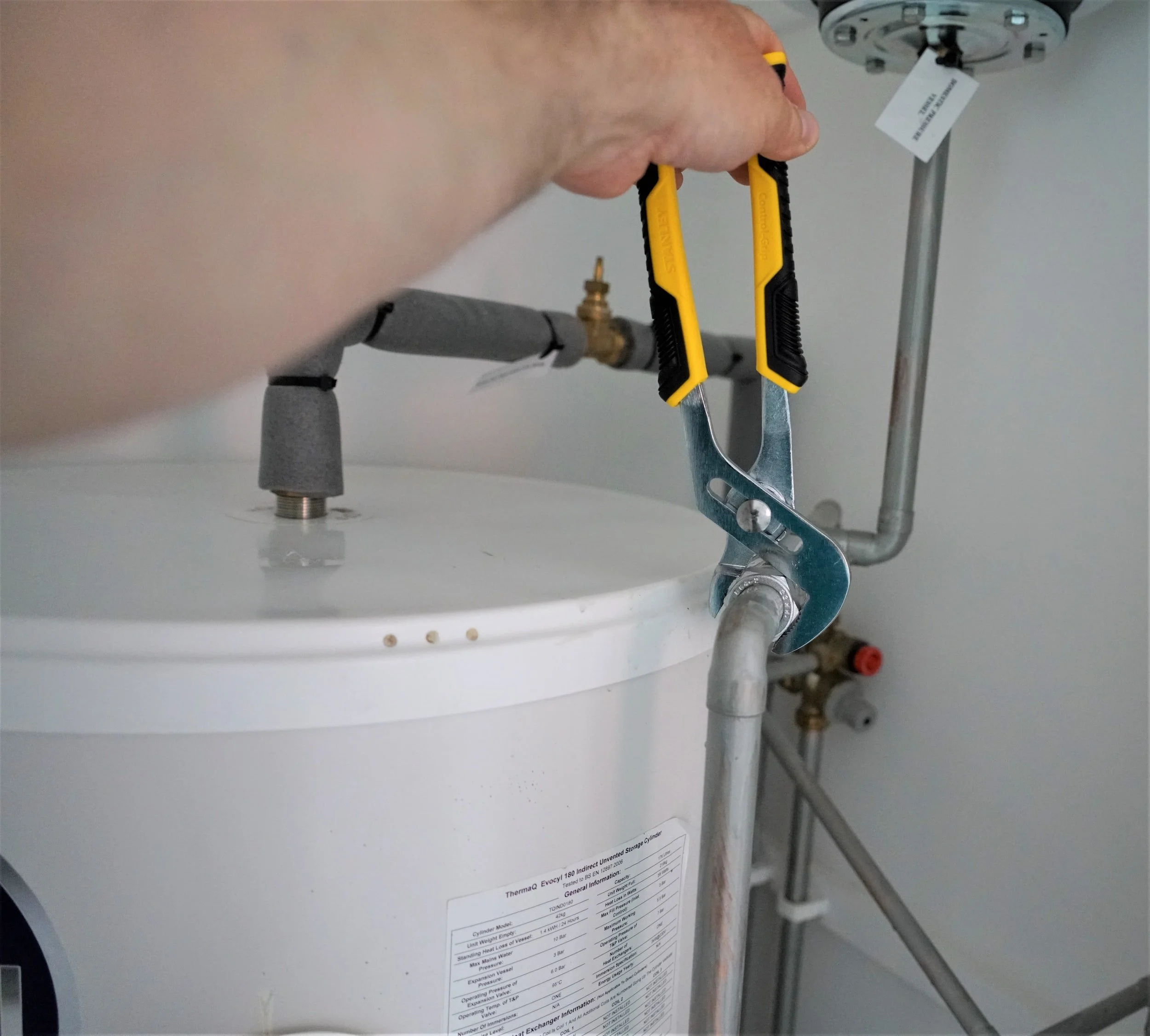 Wrench tightening a fitting on a water heater