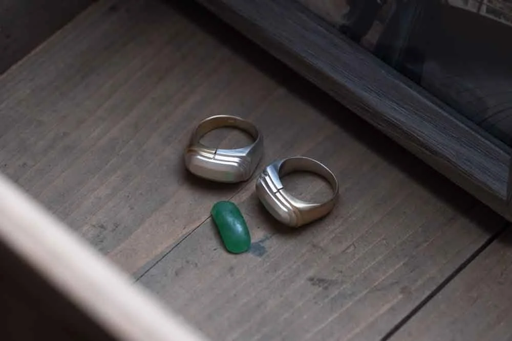 A green stone Father's Relic Transformation process showing on the wooden table