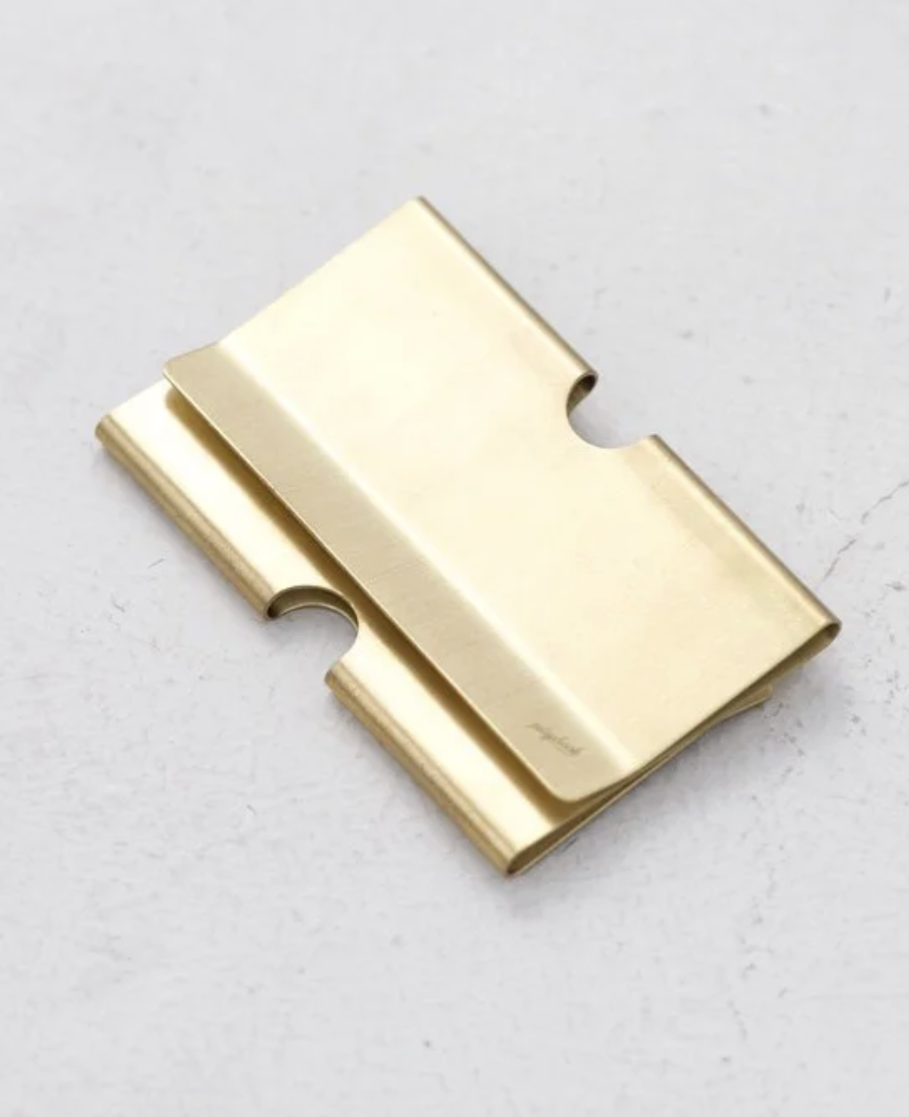A gold card clip engraving playback logo