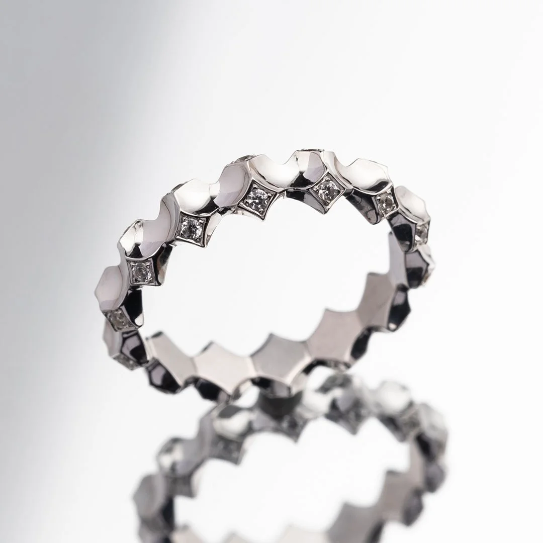 A Planetary Ring stand on a mirror surface, reflecting the ring itself