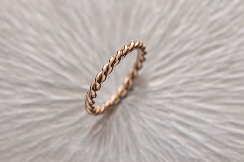 string 200% diamond ring placed on sliver surface