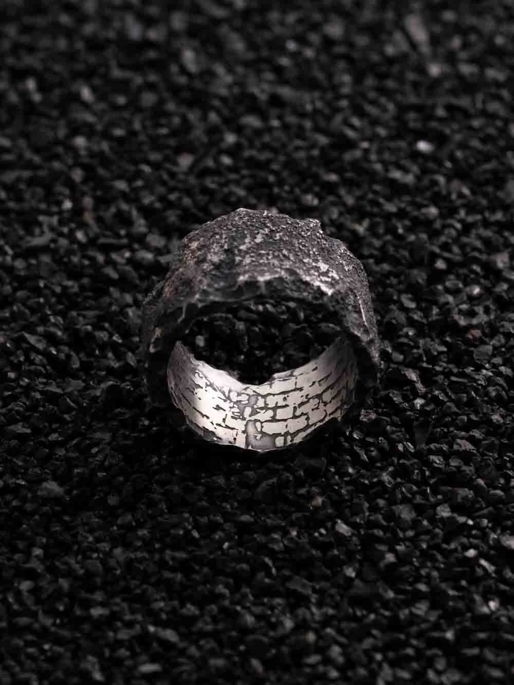 Front view of the 2073 City Decay annihilate ring with stone texture on the black sand